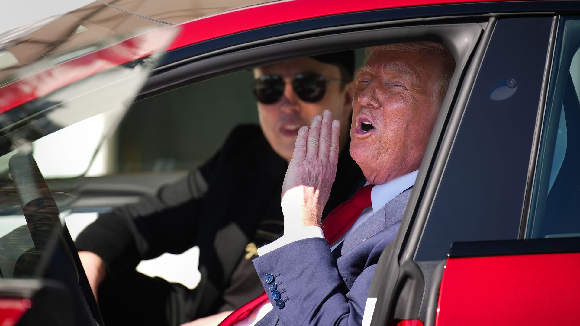 President Trump and Elon Musk in a Tesla in front of the White House.