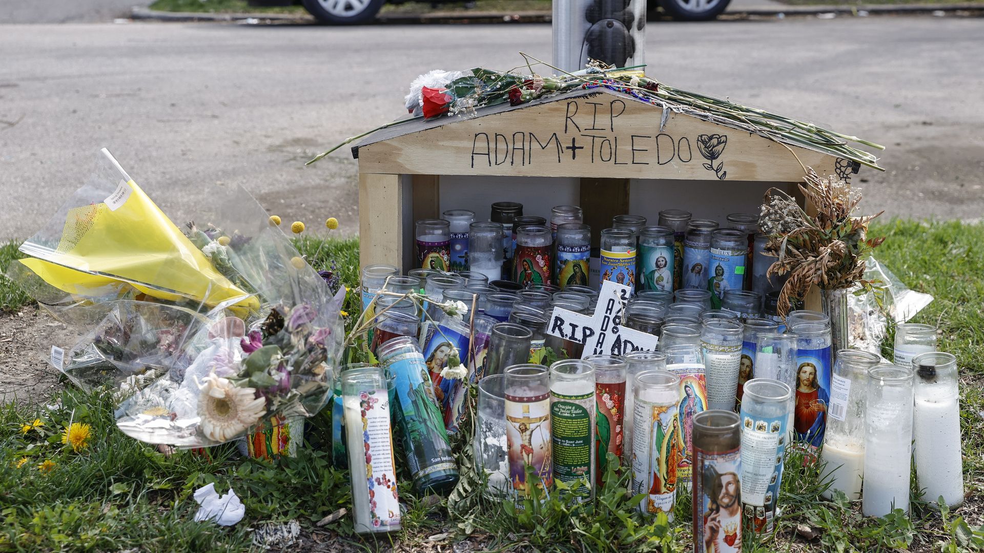 A small memorial of flowers and candles to Adam Toledo in Chicago