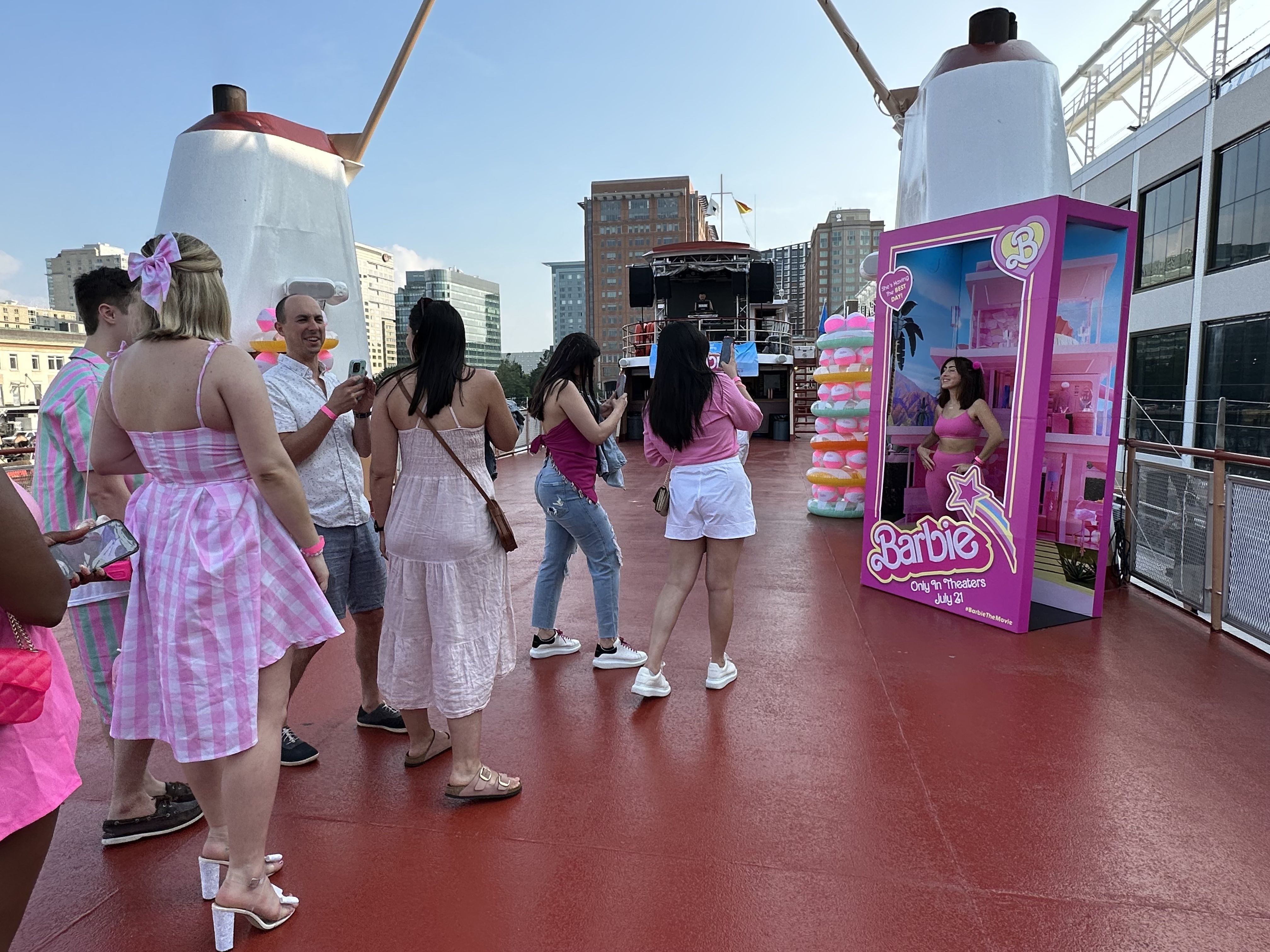 A small line forms on the top of the boat as people take photos in a life-size Barbie doll box.