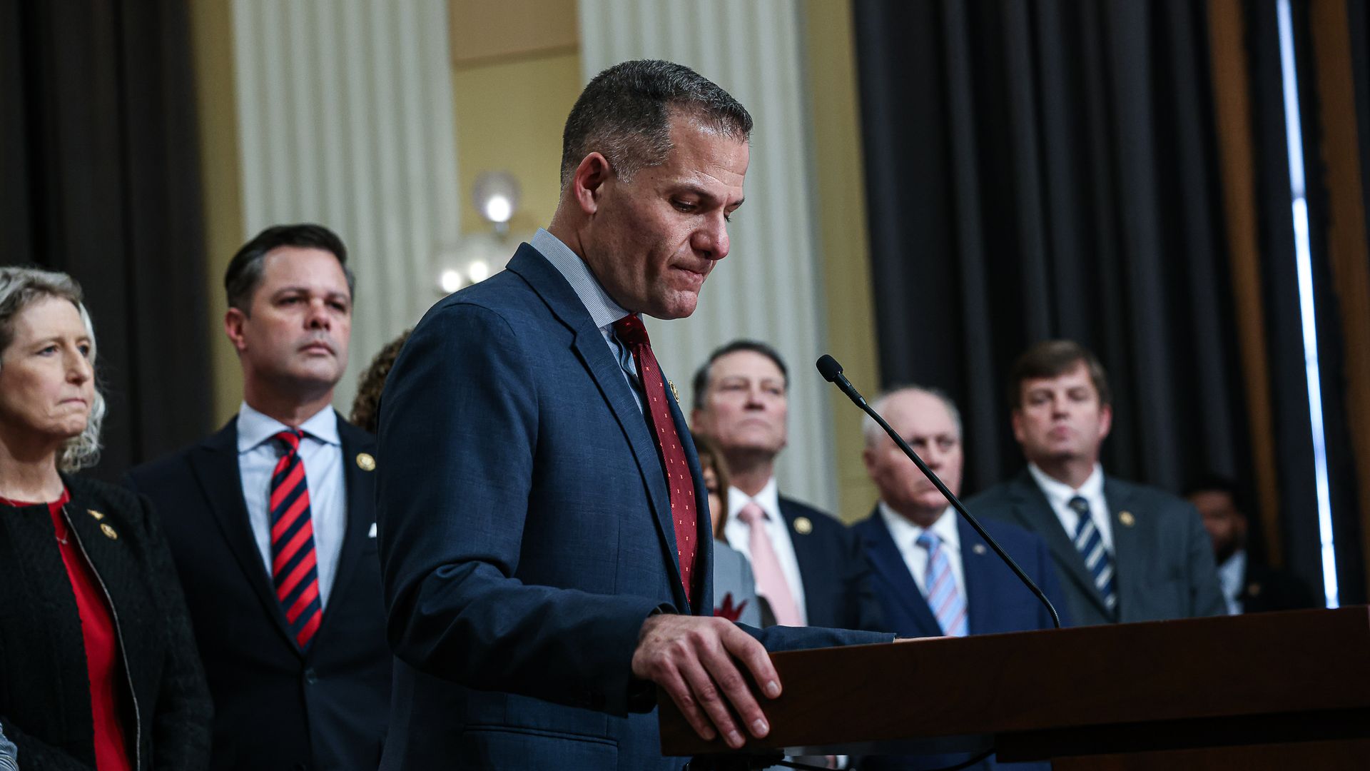 Rep. Mark Molinaro, wearing a dark blue suit, light blue shirt and red tie.