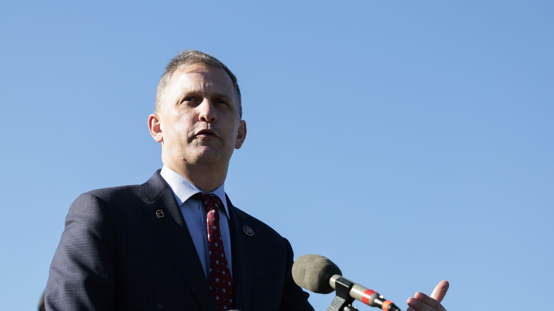 Photo of a man behind a podium.