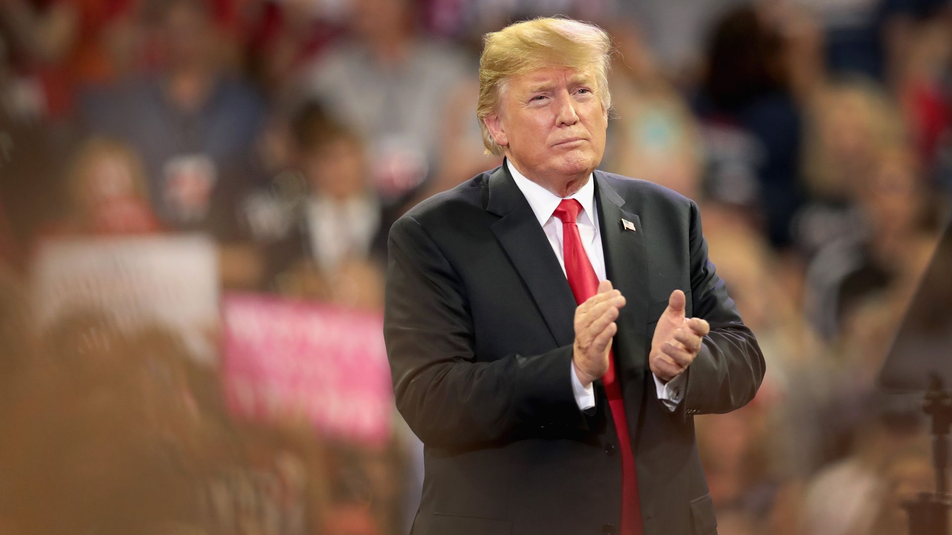 Donald Trump claps at a rally in Minnesota