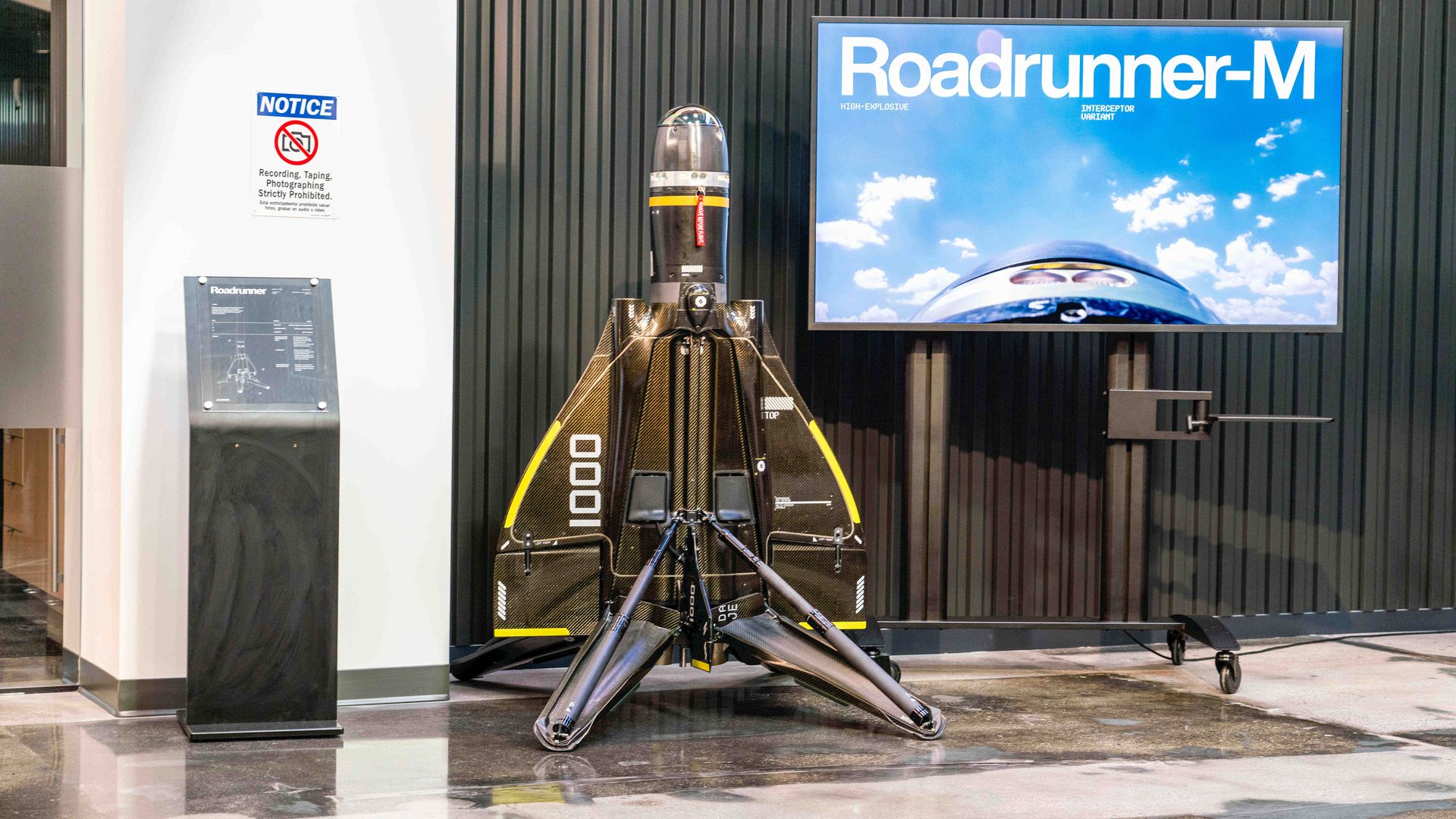An autonomous air vehicle from Anduril is presented on a stand.