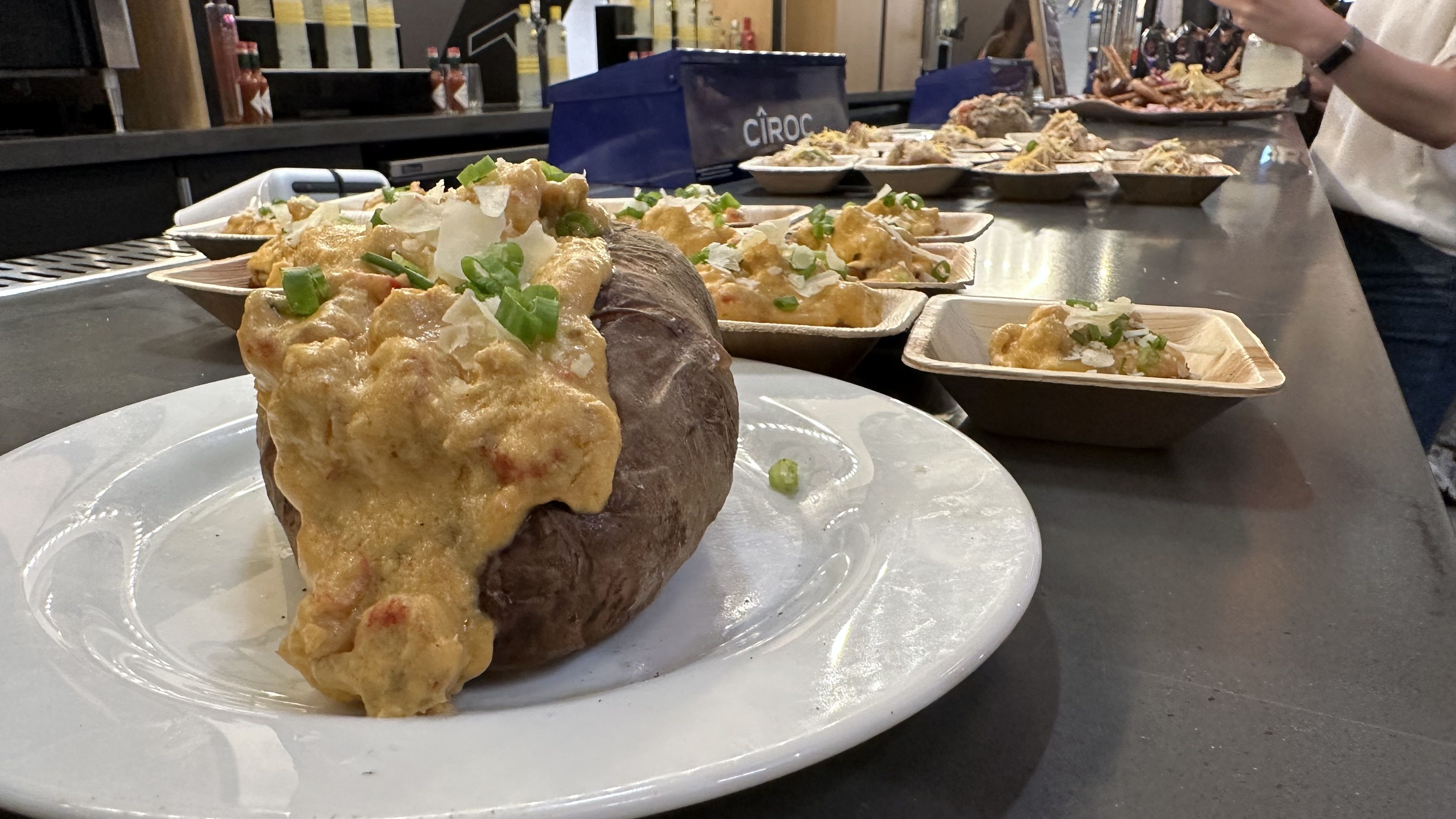 A stuffed baked potato overflows with a crawfish cream sauce.