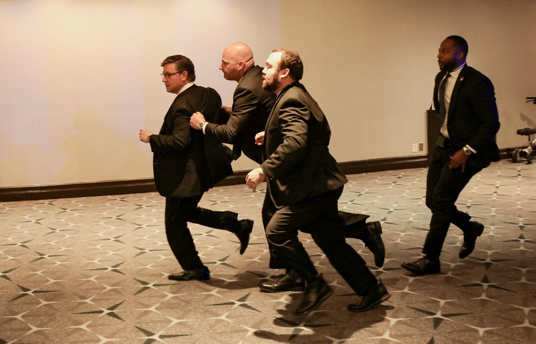 Security officials evacuate House Speaker Mike Johnson from the White House Correspondents' Association dinner.