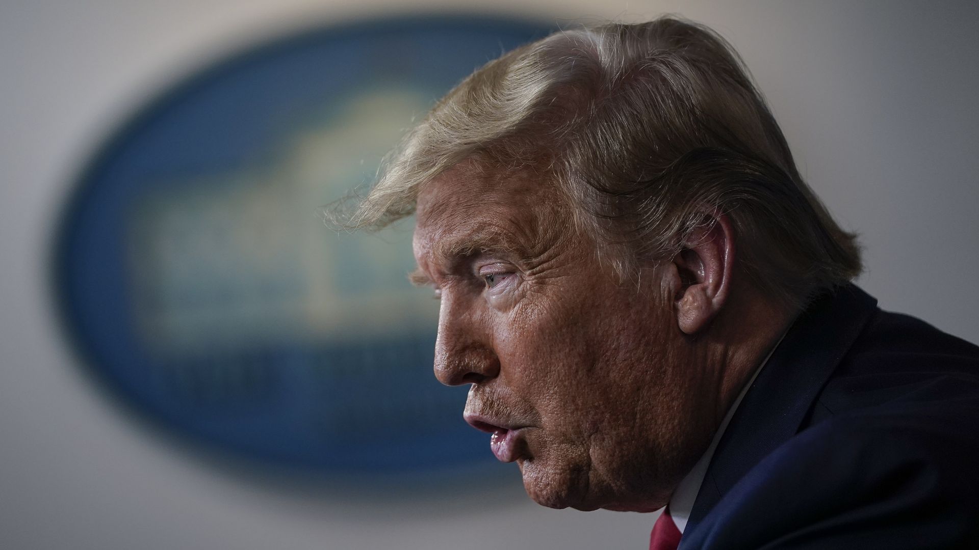 In this image, Trump stands 