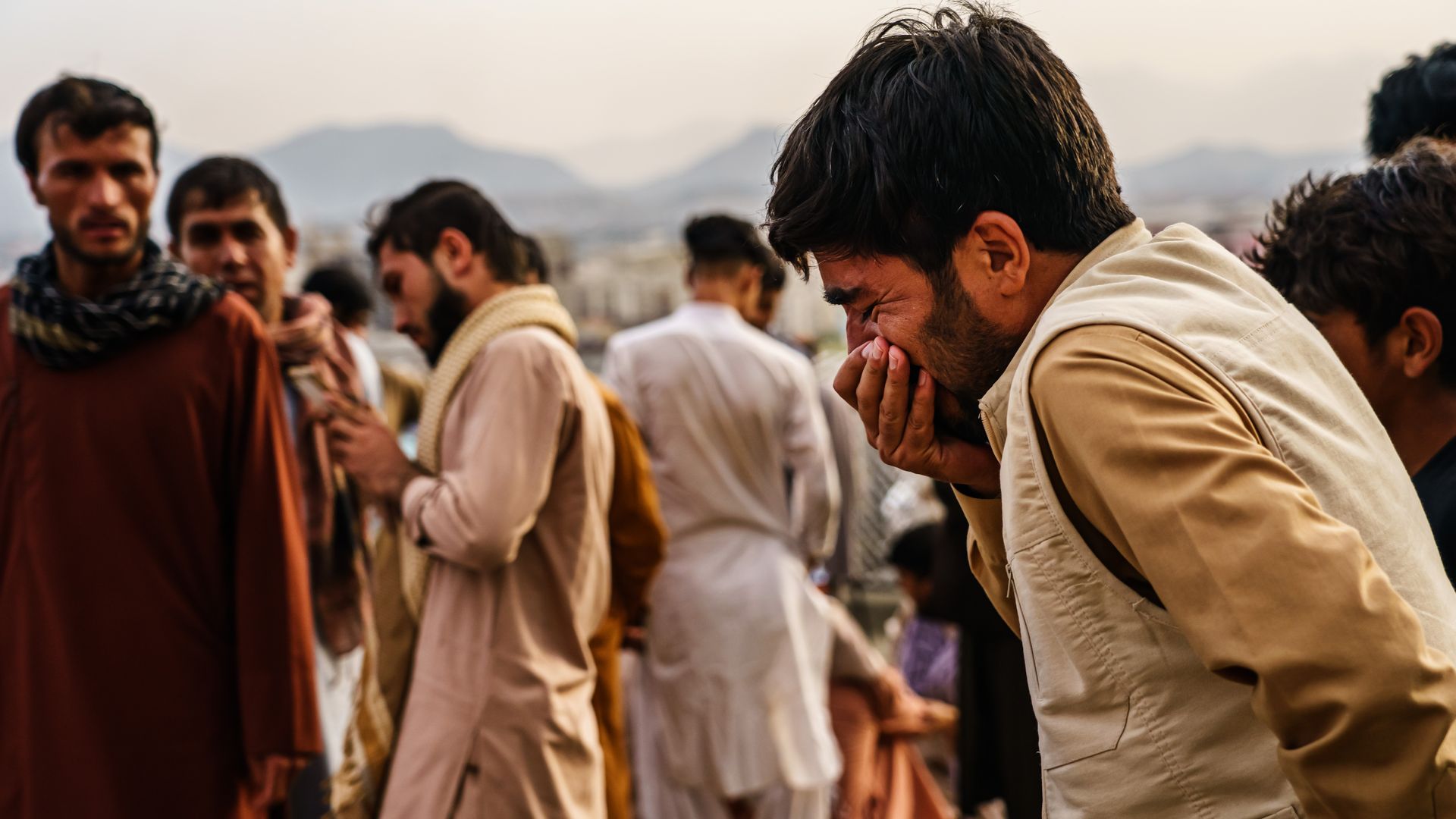 A man weeps during a mass funeral for members of a family was killed in a U.S. drone airstrike in Kabul, Afghanistan.