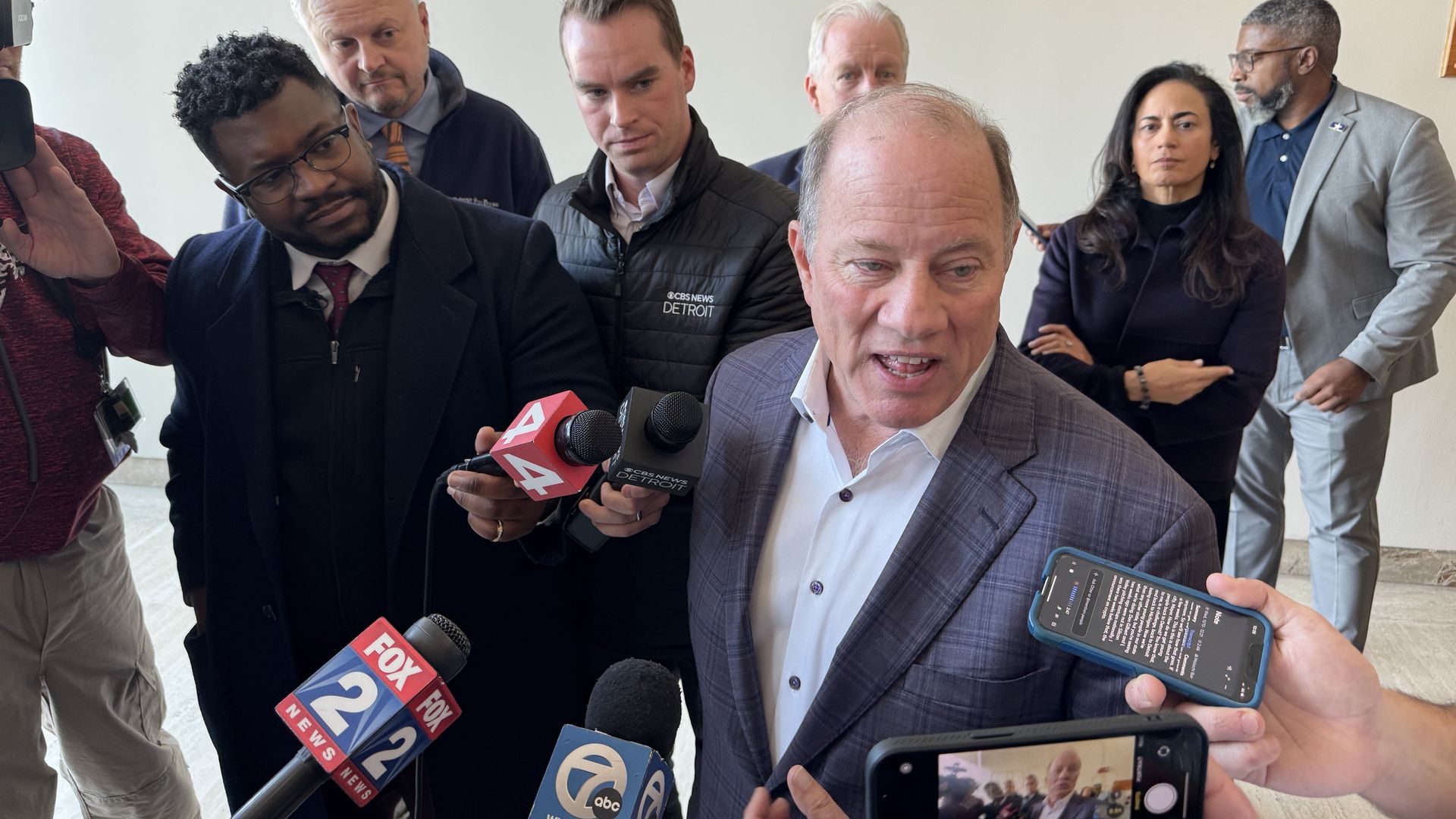 Duggan talks to reporters after the announcement.