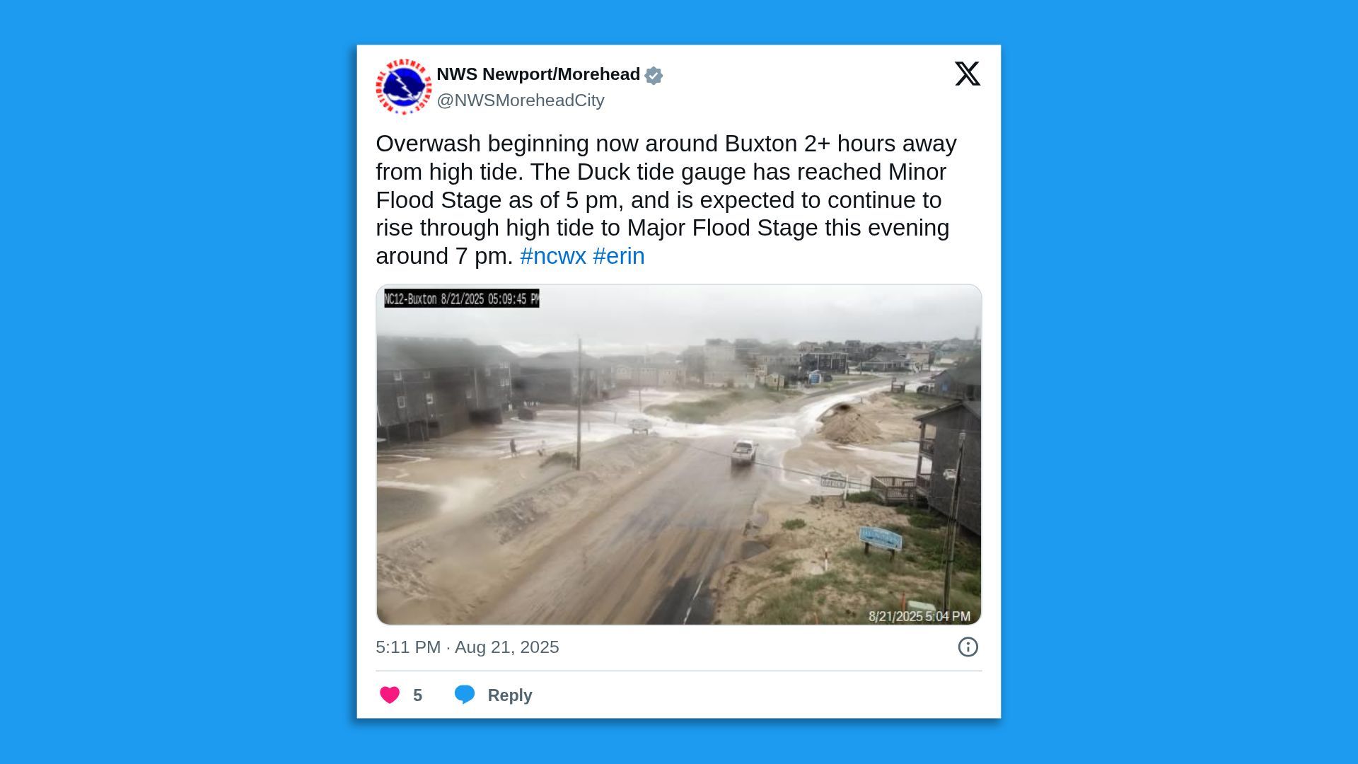 Tweet from NWS Newport/Morehead warning of overwash near Buxton with flooding expected to worsen. Image shows a flooded sandy road in a coastal town with cloudy skies and sparse buildings.