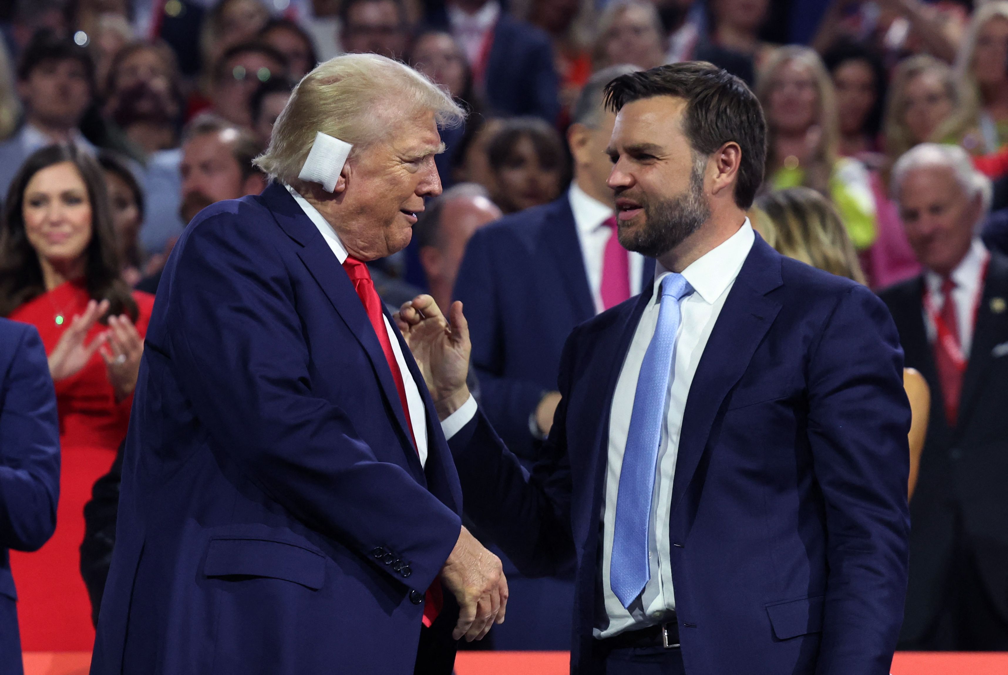 Former President Trump and Republican vice presidential nominee J.D. Vance shake hands on Day 1 of the Republican National Convention in Milwaukee last night.