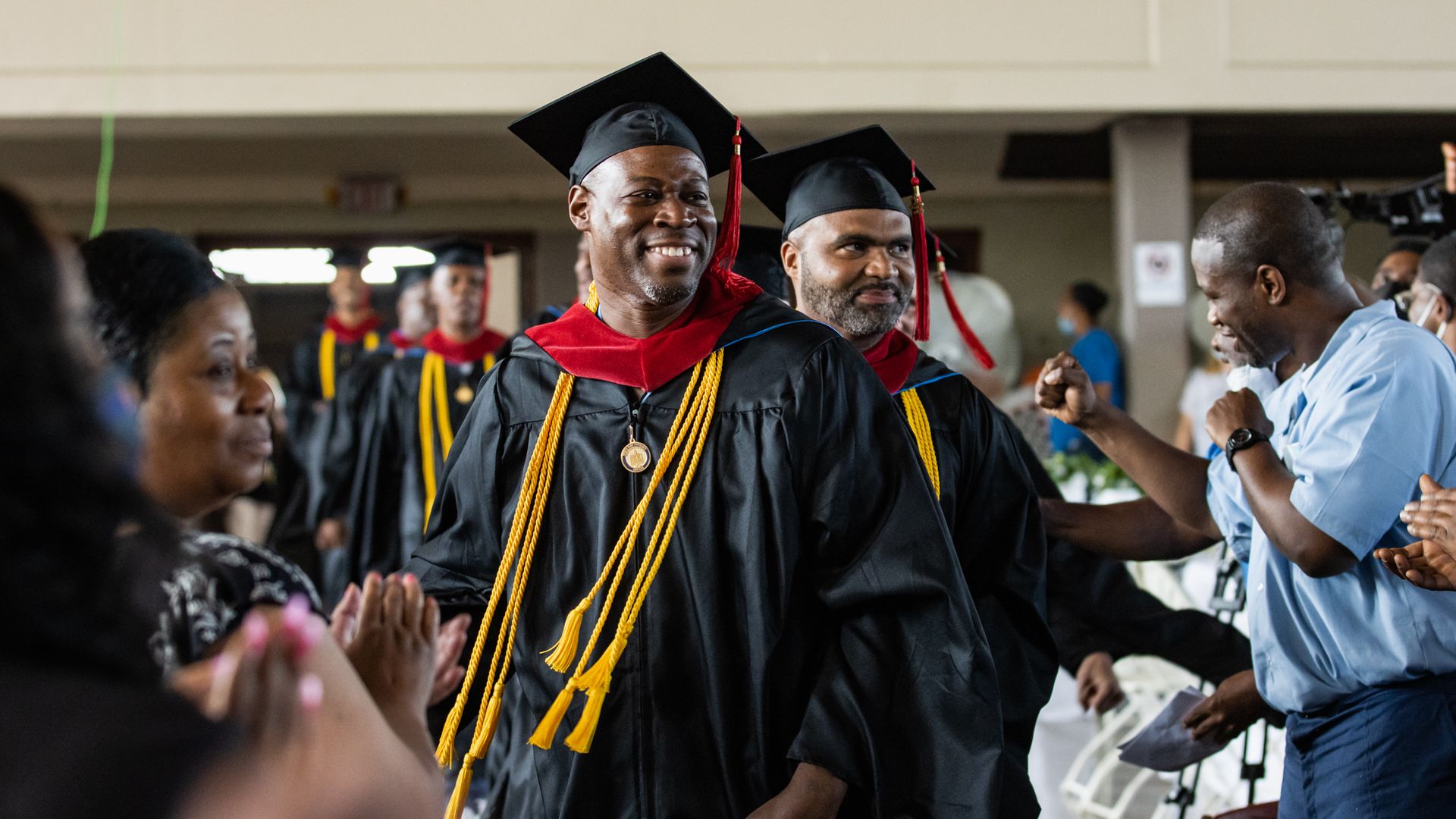 Photo of men graduating in a ceremony. 