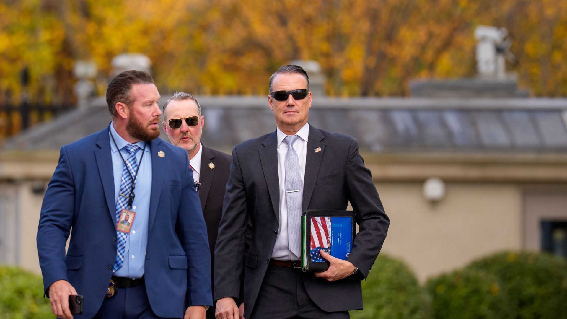 Todd Lyons walks with two other men 