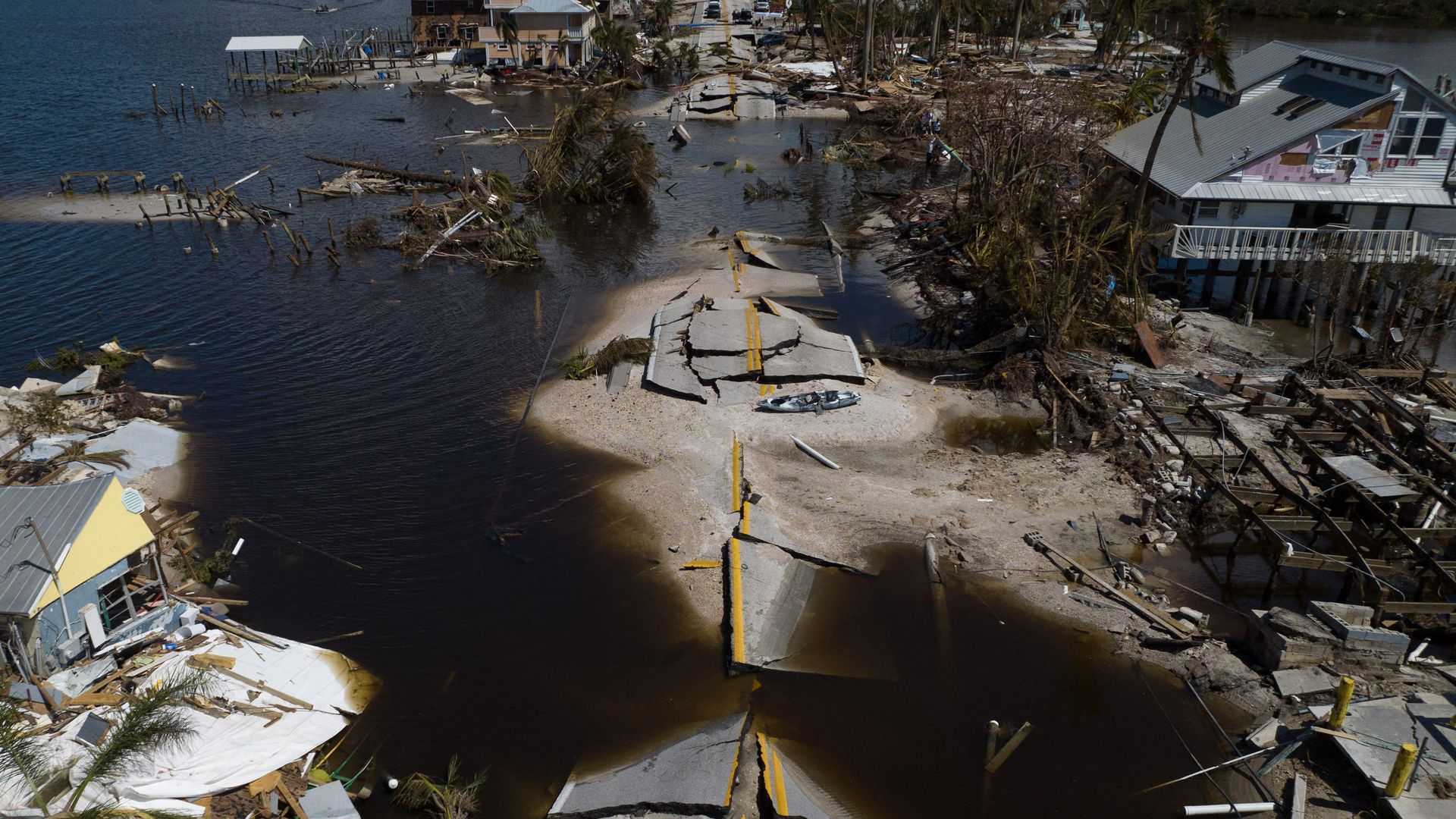 An aerial picture taken on October 1, 2022 shows a broken section of the Pine Island Road, debris and destroyed houses in the aftermath of Hurricane Ian 
