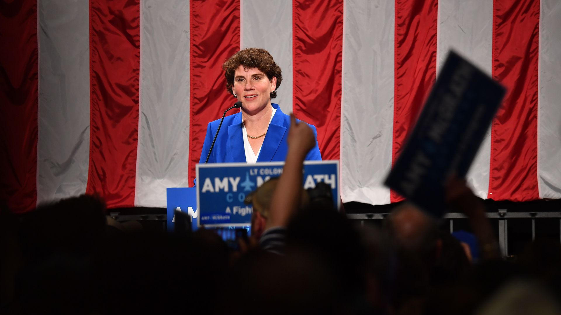 Amy McGrath smiles before campaign crowd.