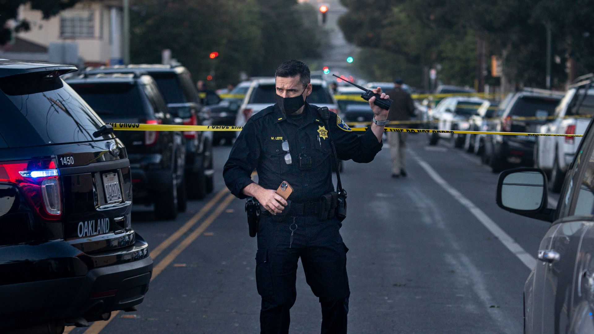 Officer emerges from a taped off crime scene