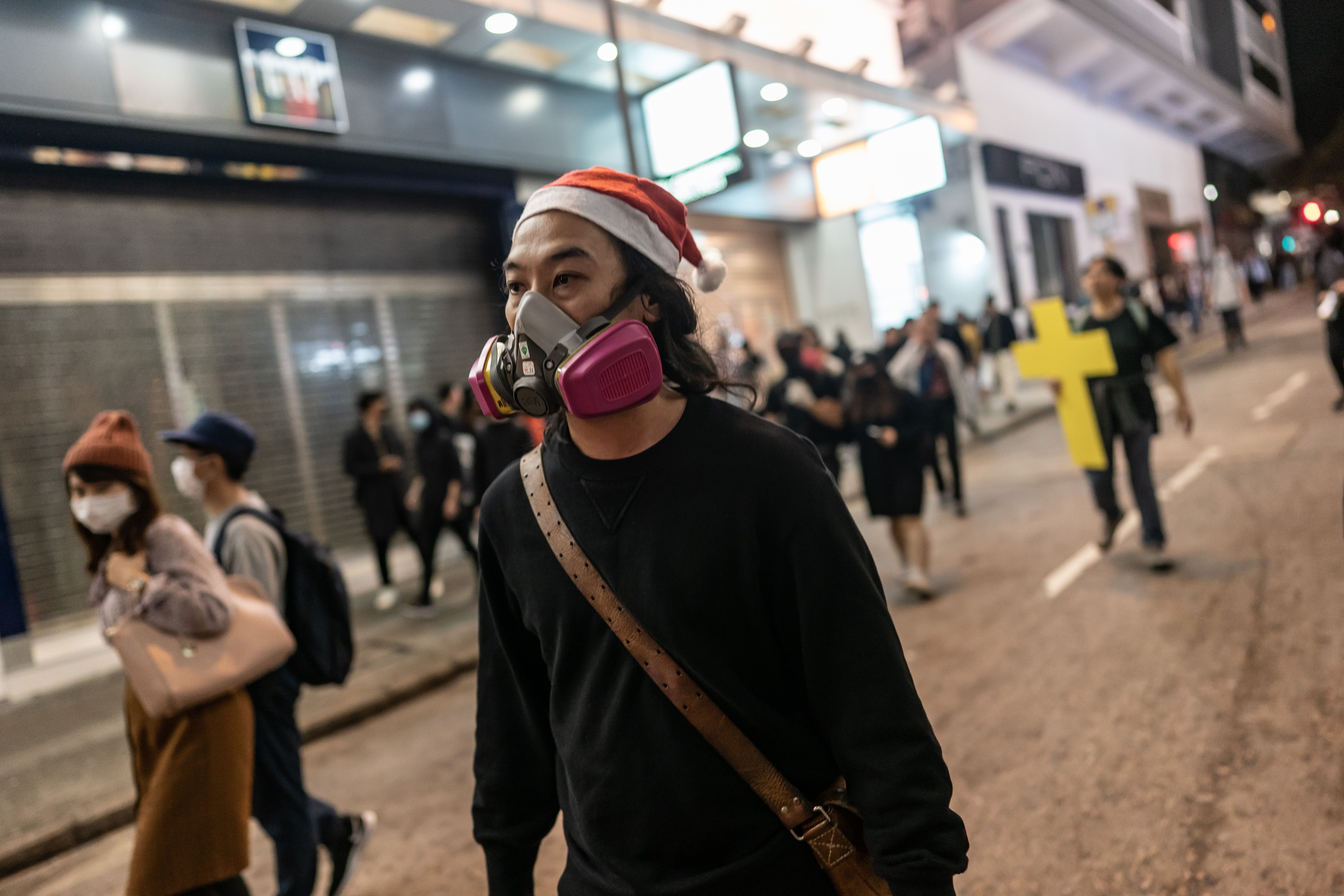 Protesters march on a street during a demonstration on December 24, 2019 in Hong Kong