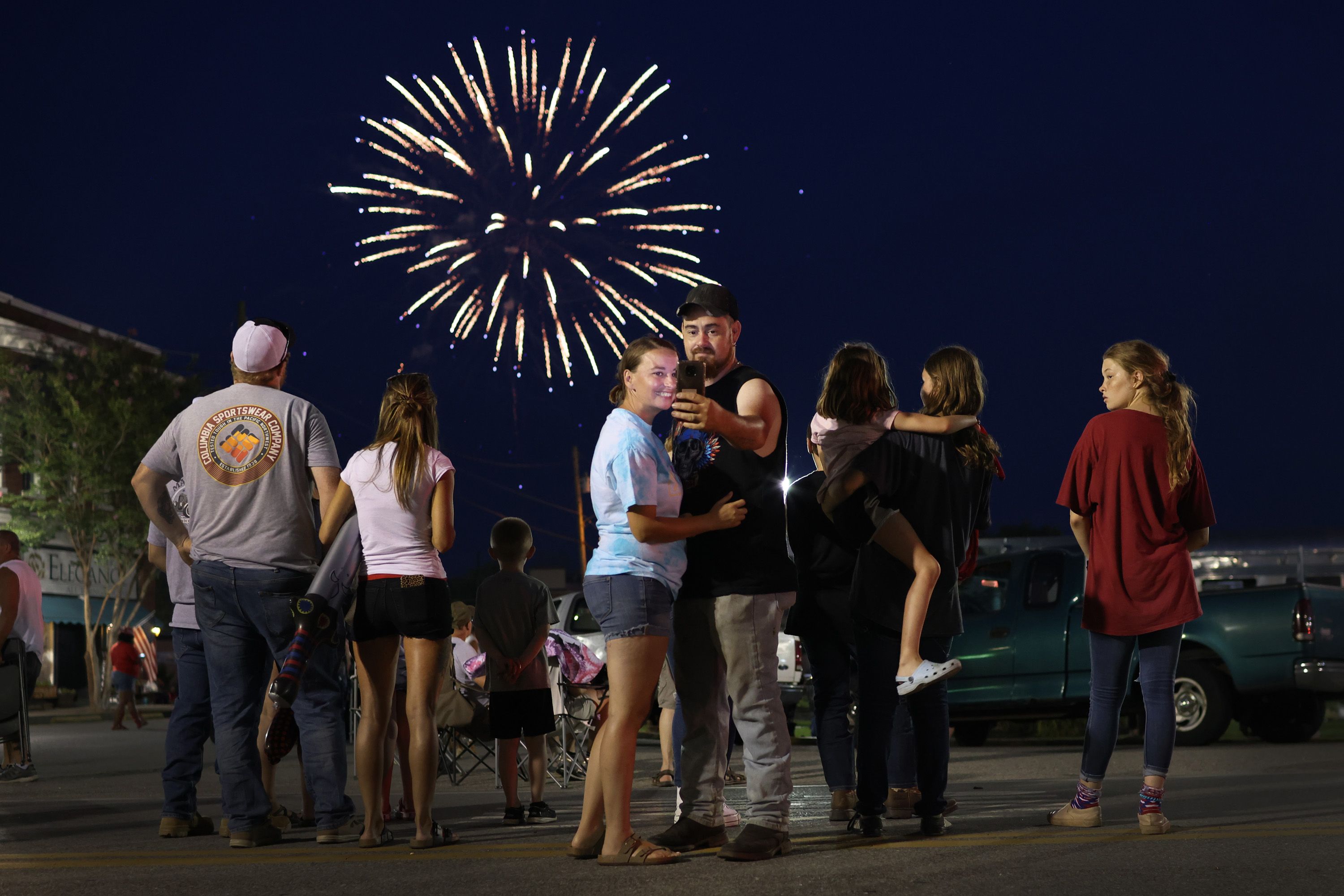  People gather along Main Street to watch fireworks while celebrating Independence Day on July 04