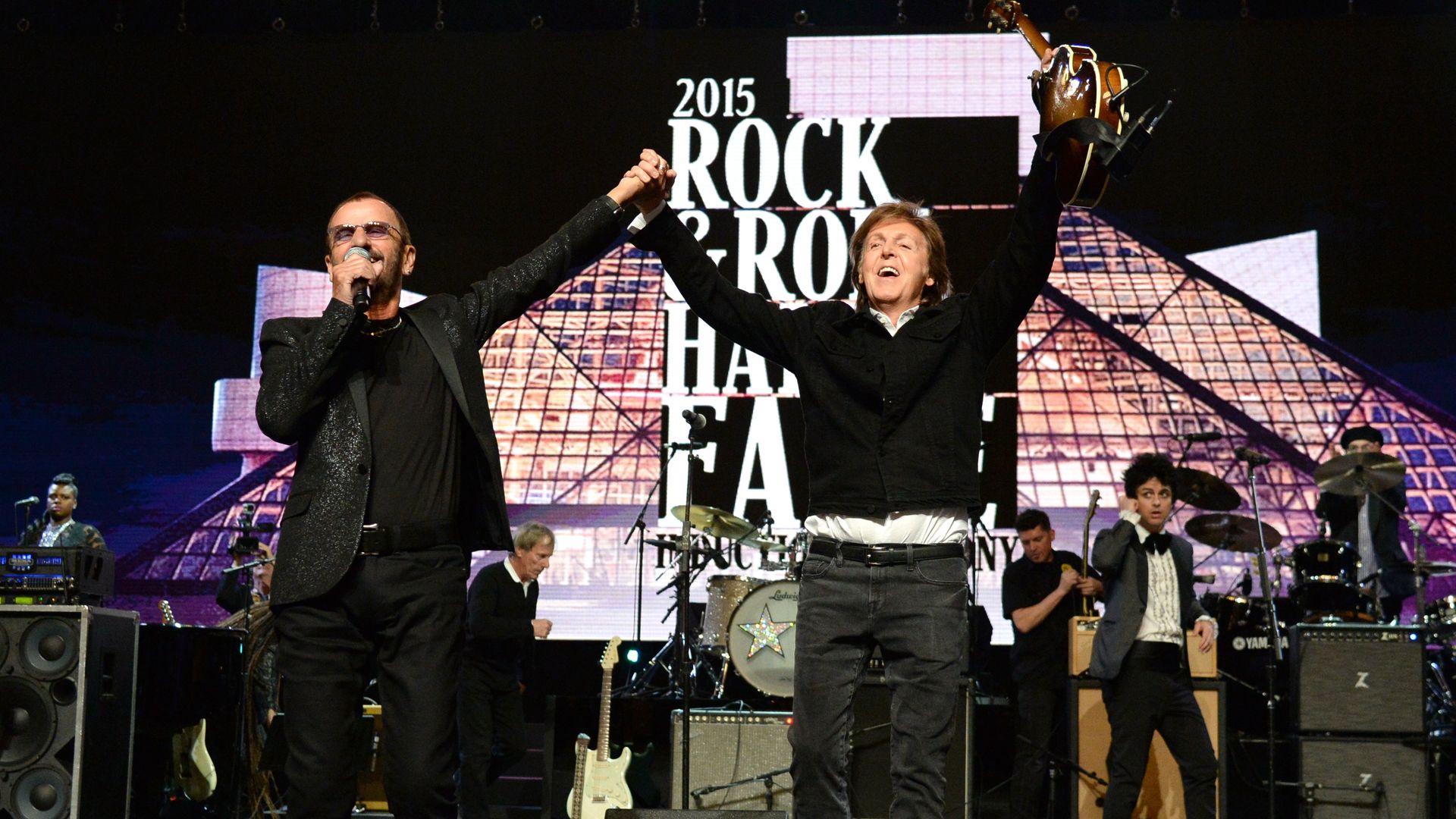 Ringo Starr and Paul McCartney hold their hands up together after performing onstage during the 30th Annual Rock And Roll Hall Of Fame Induction Ceremony. 
