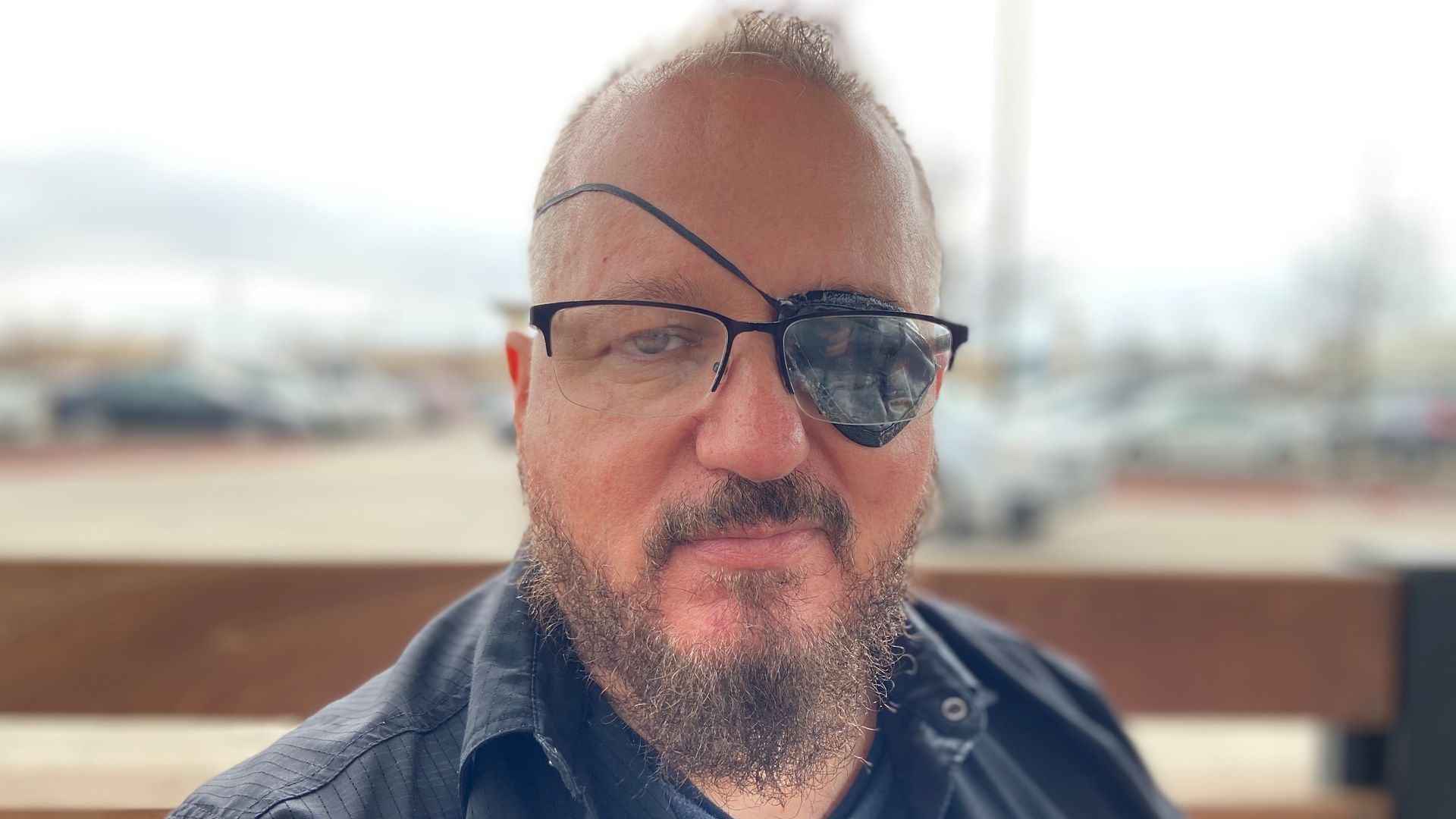 Oath Keepers leader Stewart Rhodes pictured with glasses and an eye patch