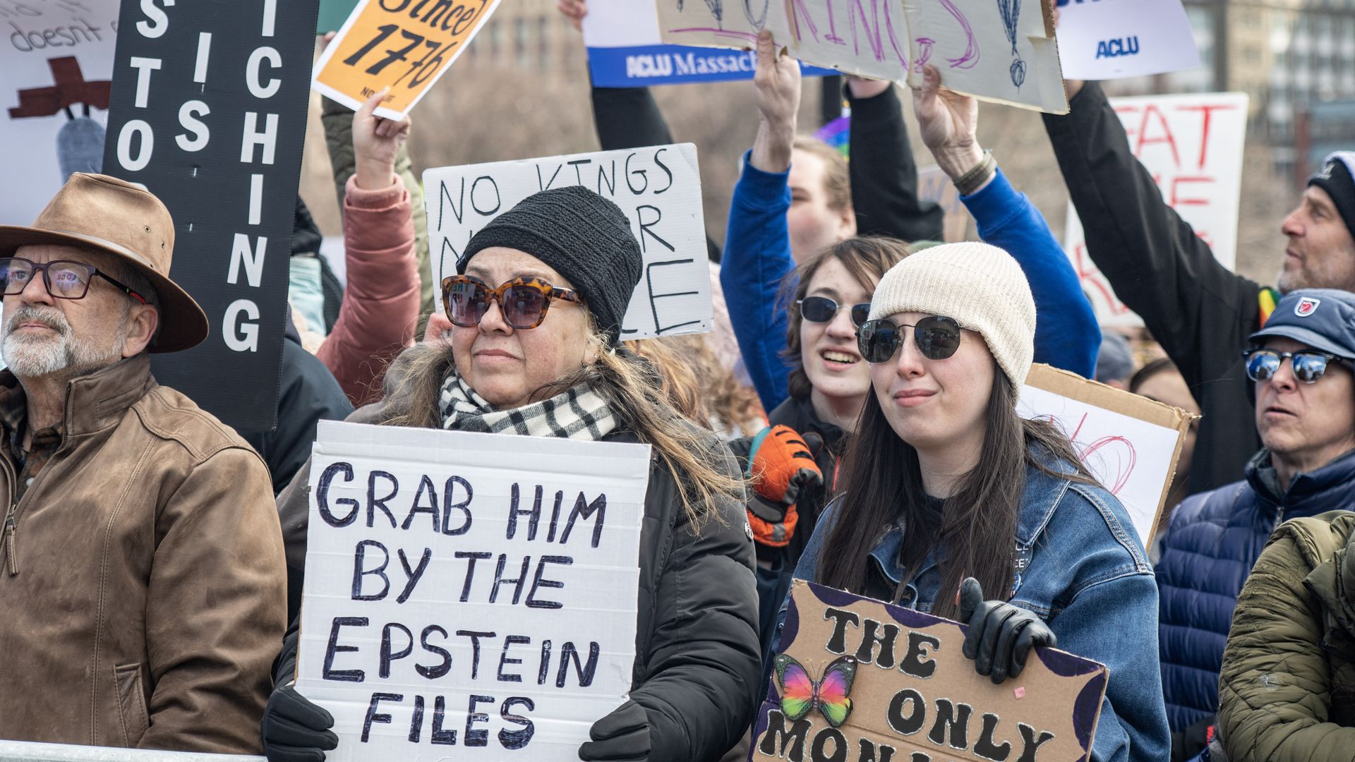 A person holds a sign reading "grab him by the Epstein files" as they gather at Boston Common during the "No Kings" national day of protest in Boston on March 28, 2026.