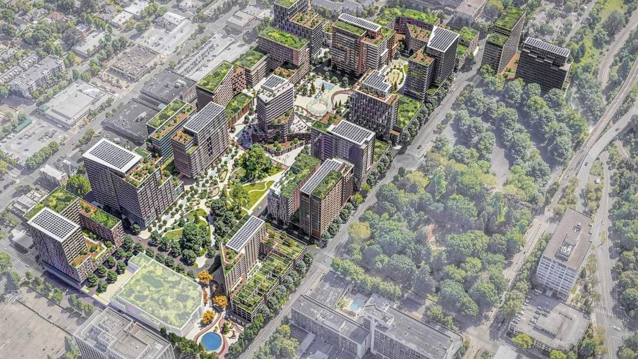Aerial rendering shows the proposed Lloyd Center redevelopment with mid- and high-rise buildings, green roofs, tree-lined plazas and a central park, replacing the existing mall site with housing and retail.