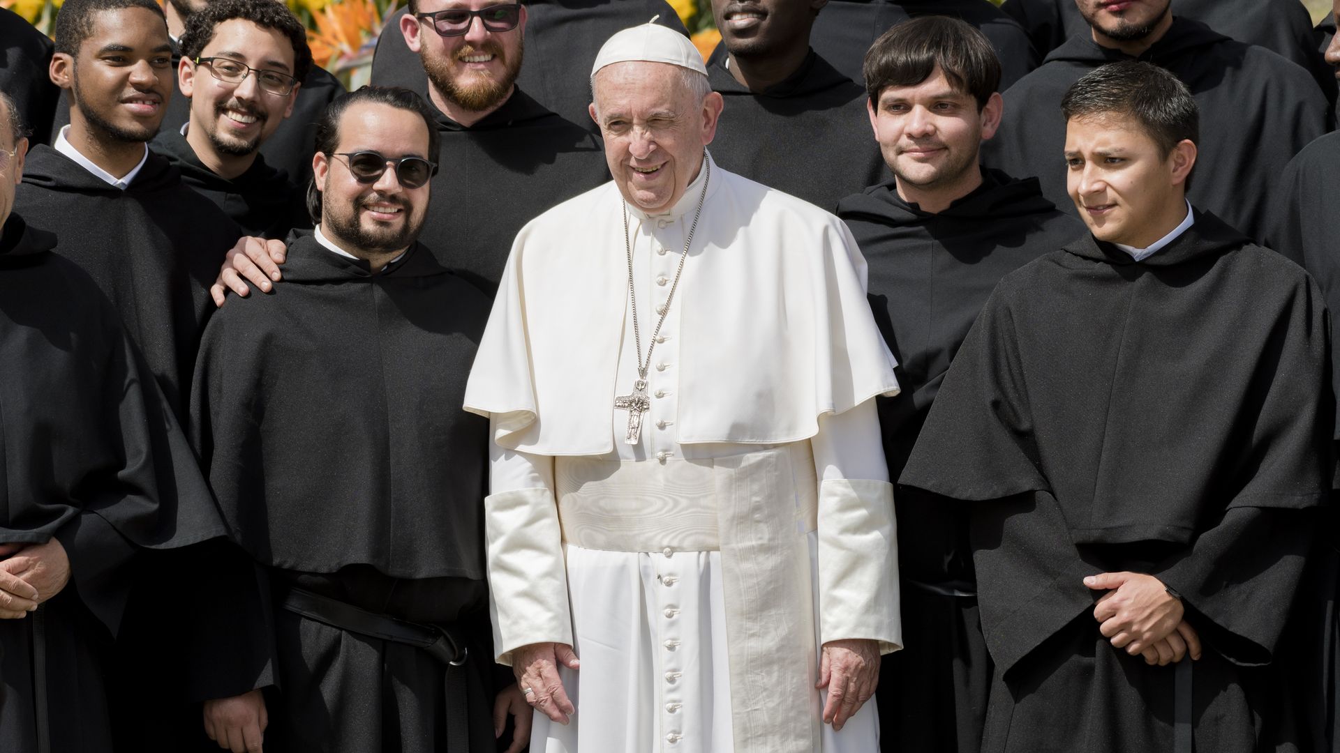 Pope francis standing with priests