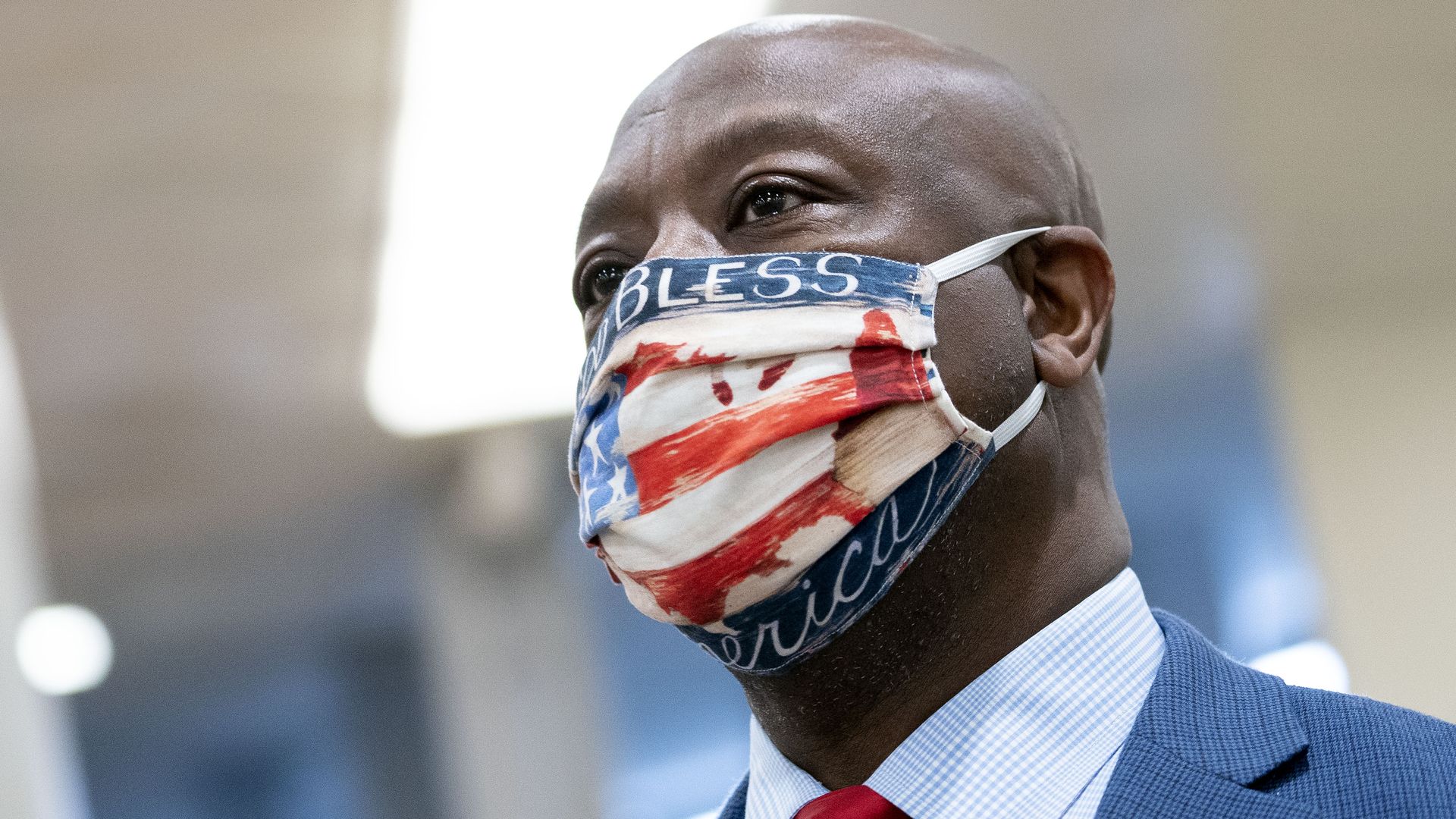 Photo of Tim Scott wearing a face mask with the American flag design