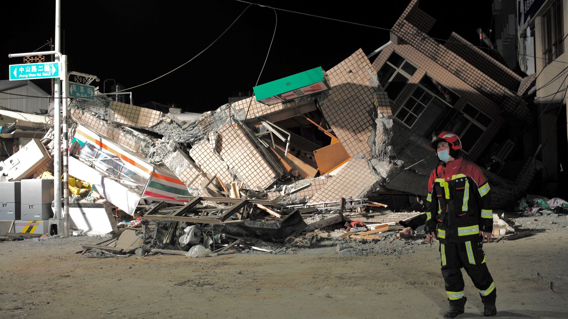 A rescuer walking past a collapsed building after an earthquake at Yuli, Taiwan, on Sept. 18.