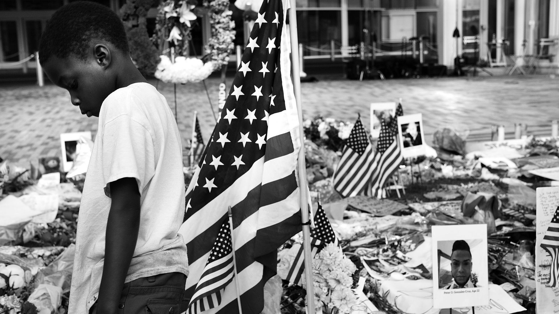 A child pauses at a memorial to victims of the Pulse nightclub shooting on June 17, 2016 in Orlando, Florida. 