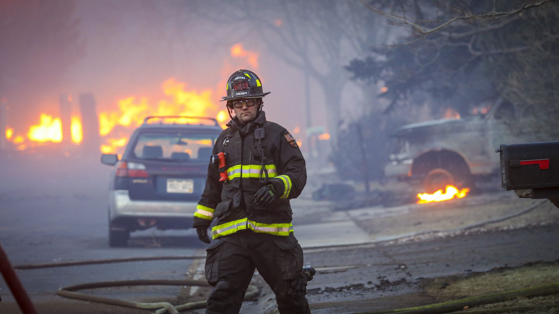 An Arvada firefighter walks back to the firetruck as a fast moving wildfire swept through the area in a Louisville neighborhood, destroying cars and homes. Photo: Marc Piscotty/Getty Images