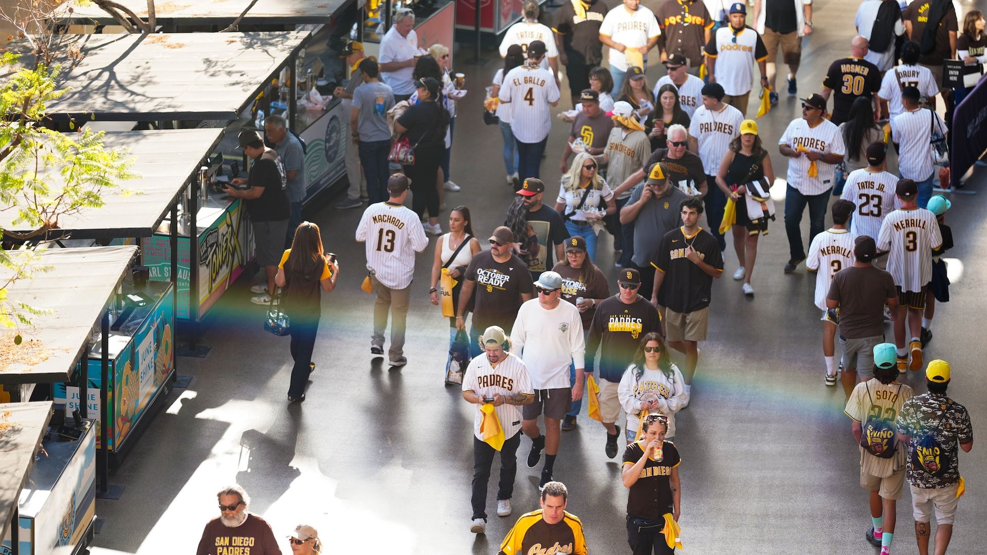 San Diego Padres fans walk by food stands along the concourse at Petco Park. 