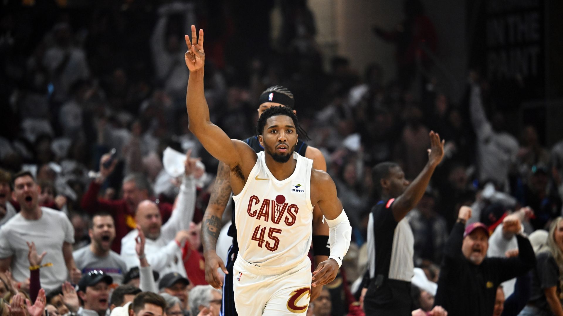 Cavaliers guard Donovan Mitchell holds up three fingers after hitting a shot. 