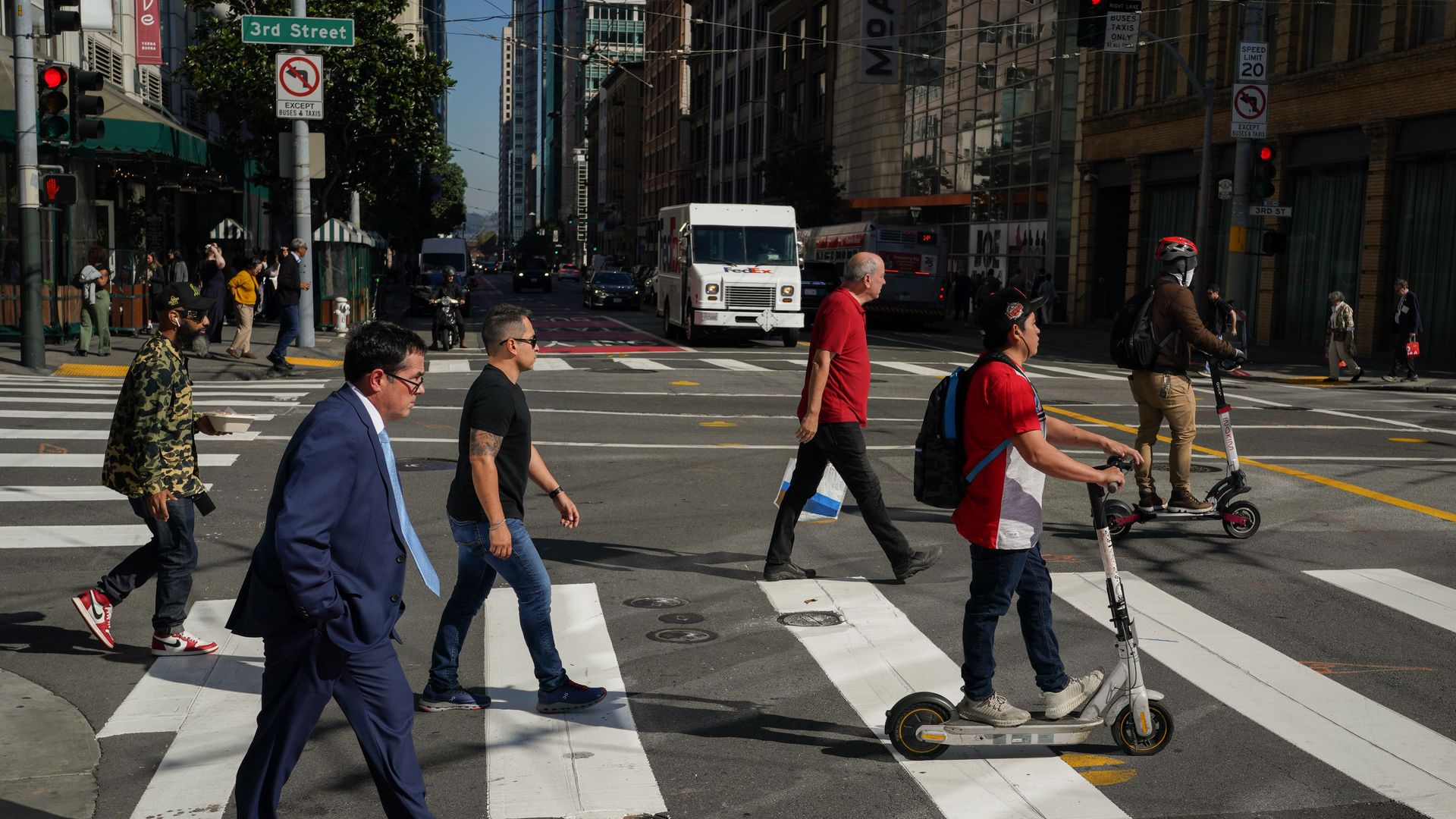 people walking in a crosswalk