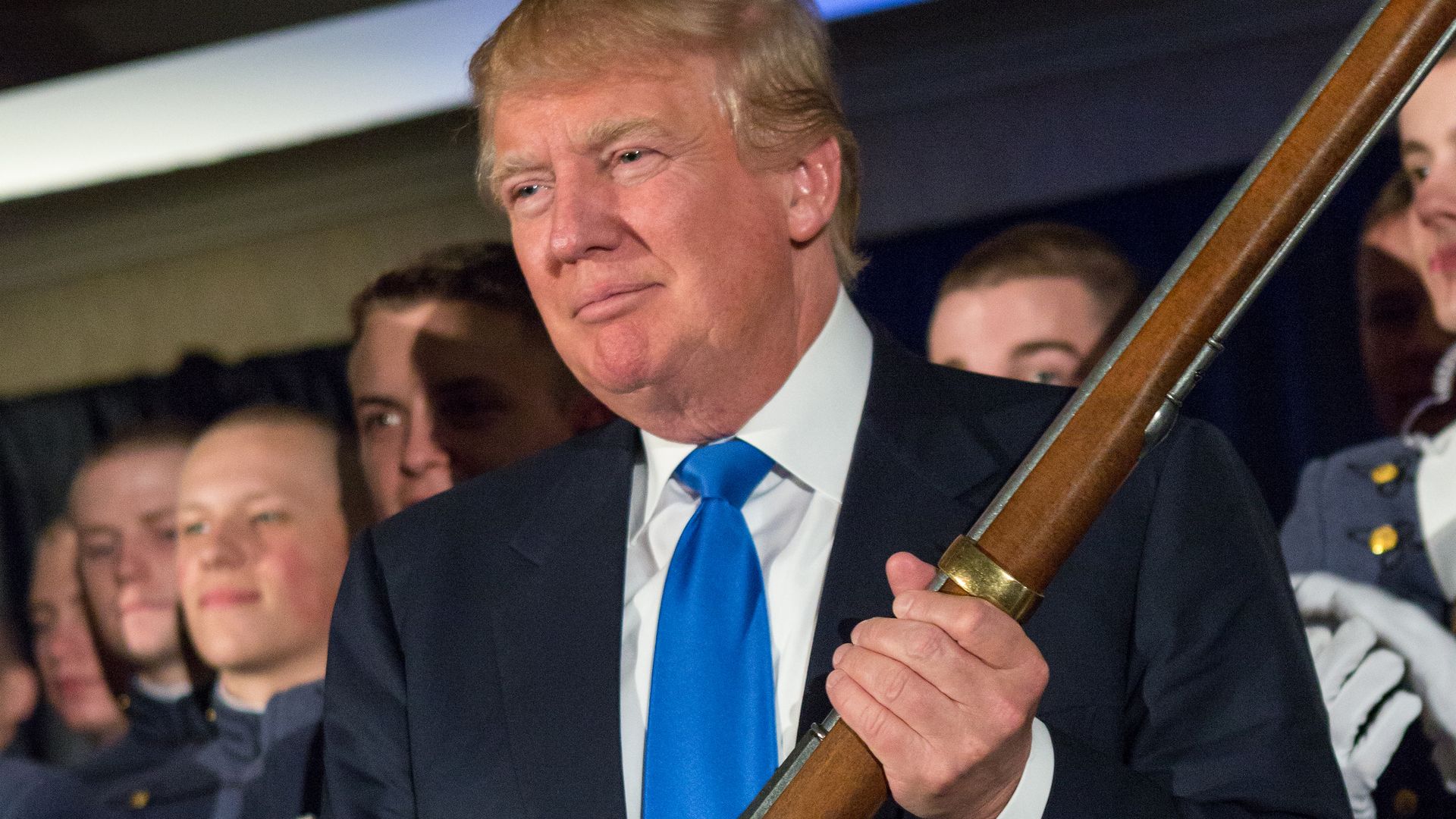 Donald Trump holding a flintlock rifle