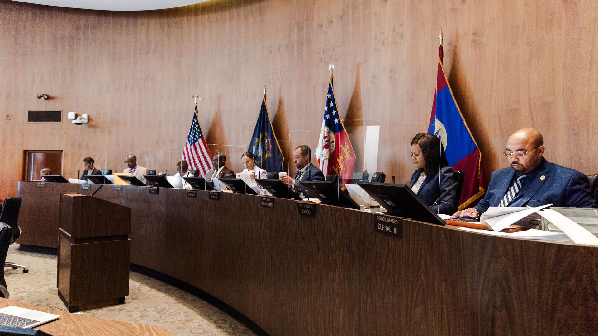 City council members at the table deliberating.