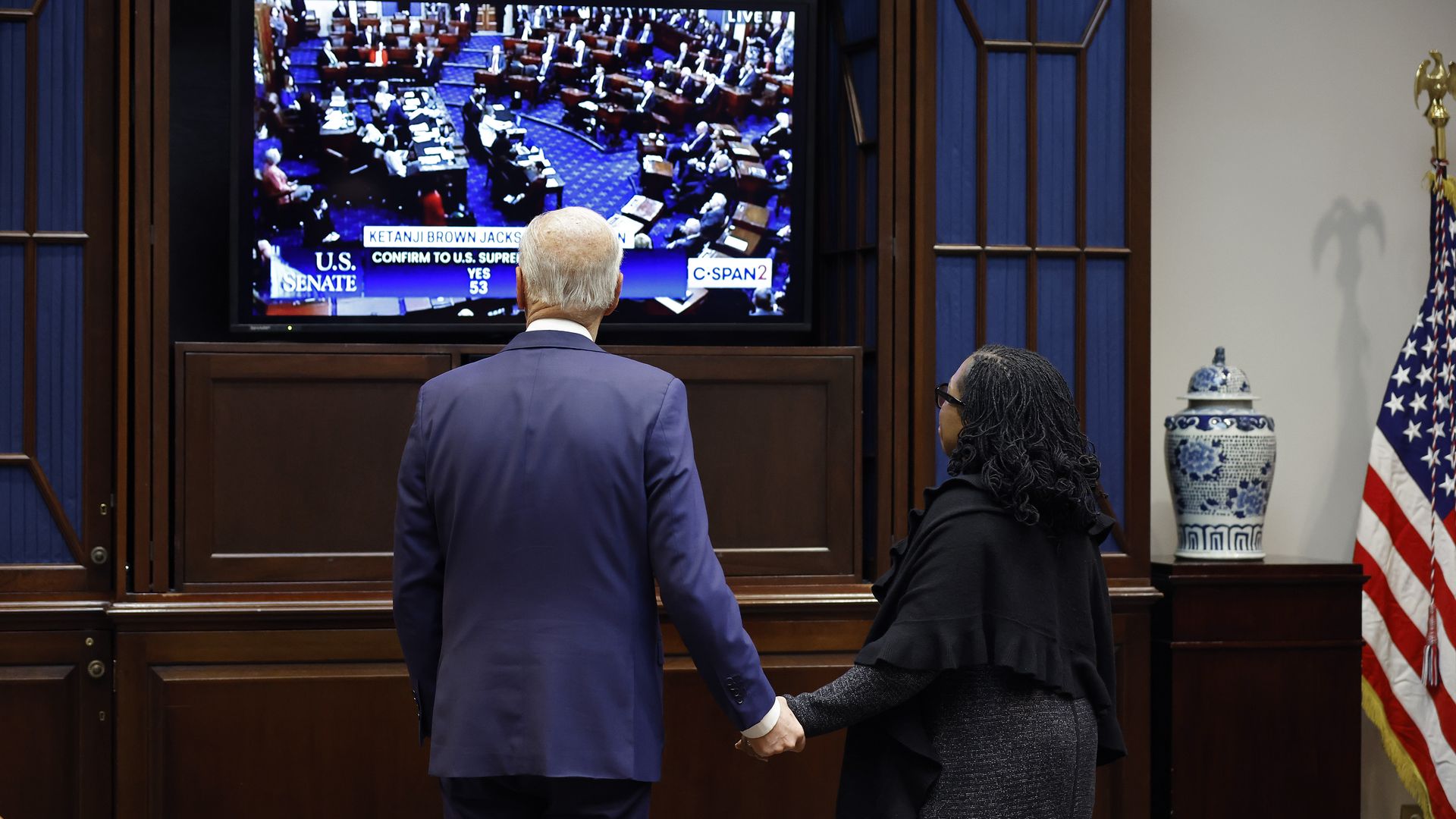 President Biden is seen holding hands with Ketanji Brown Jackson as the Senate votes to confirm her to the Supreme Court.