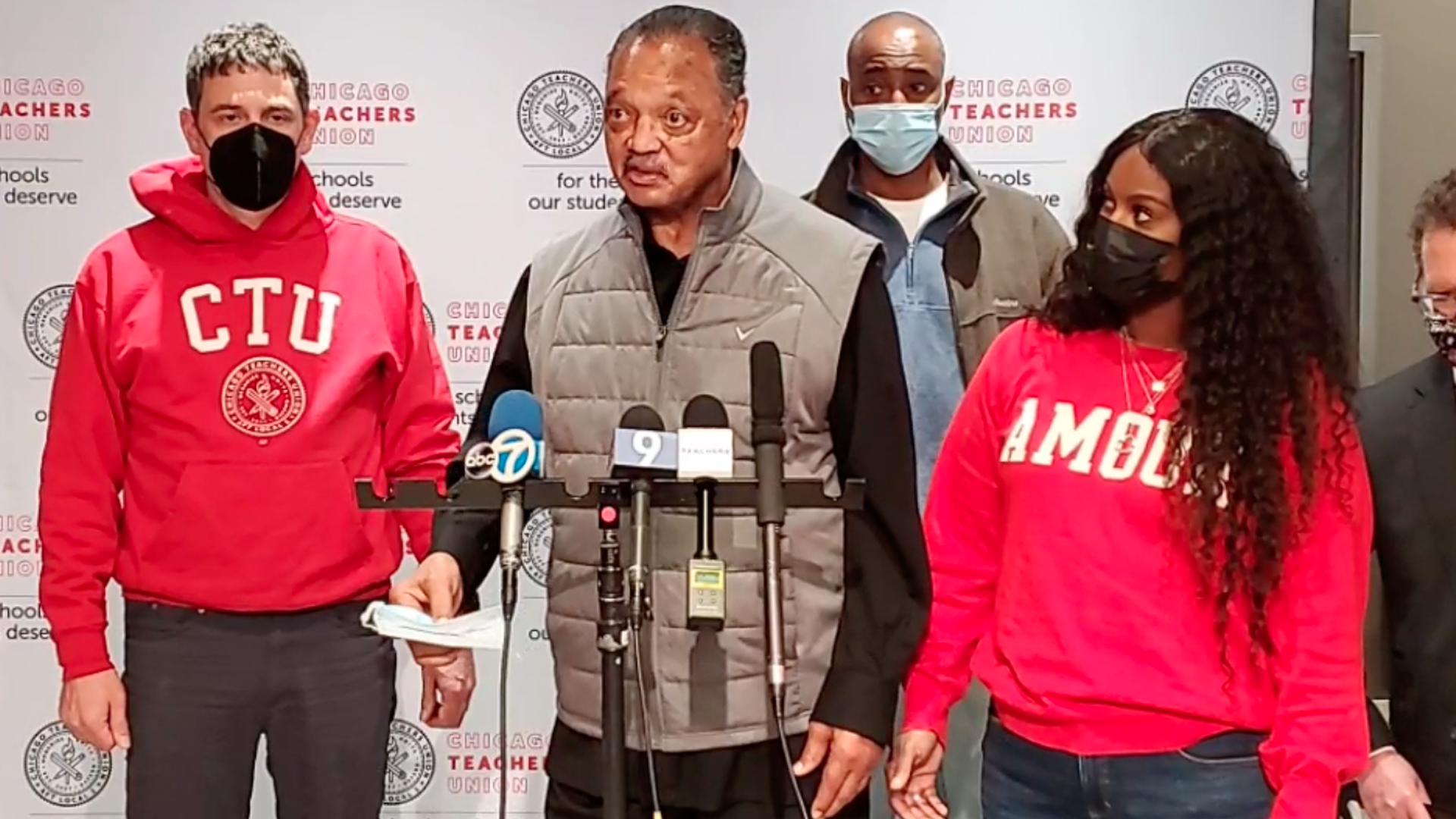 Jesse Jackson speaking at a mic. 