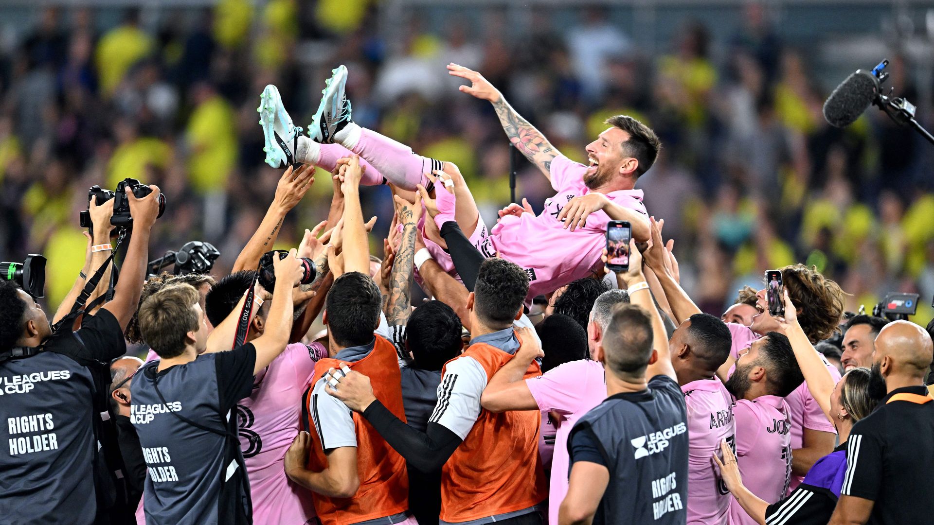 Teammates hold up Inter Miami's Argentine forward #10 Lionel Messi as they celebrate after winning the Leagues Cup final football match against Nashville SC 