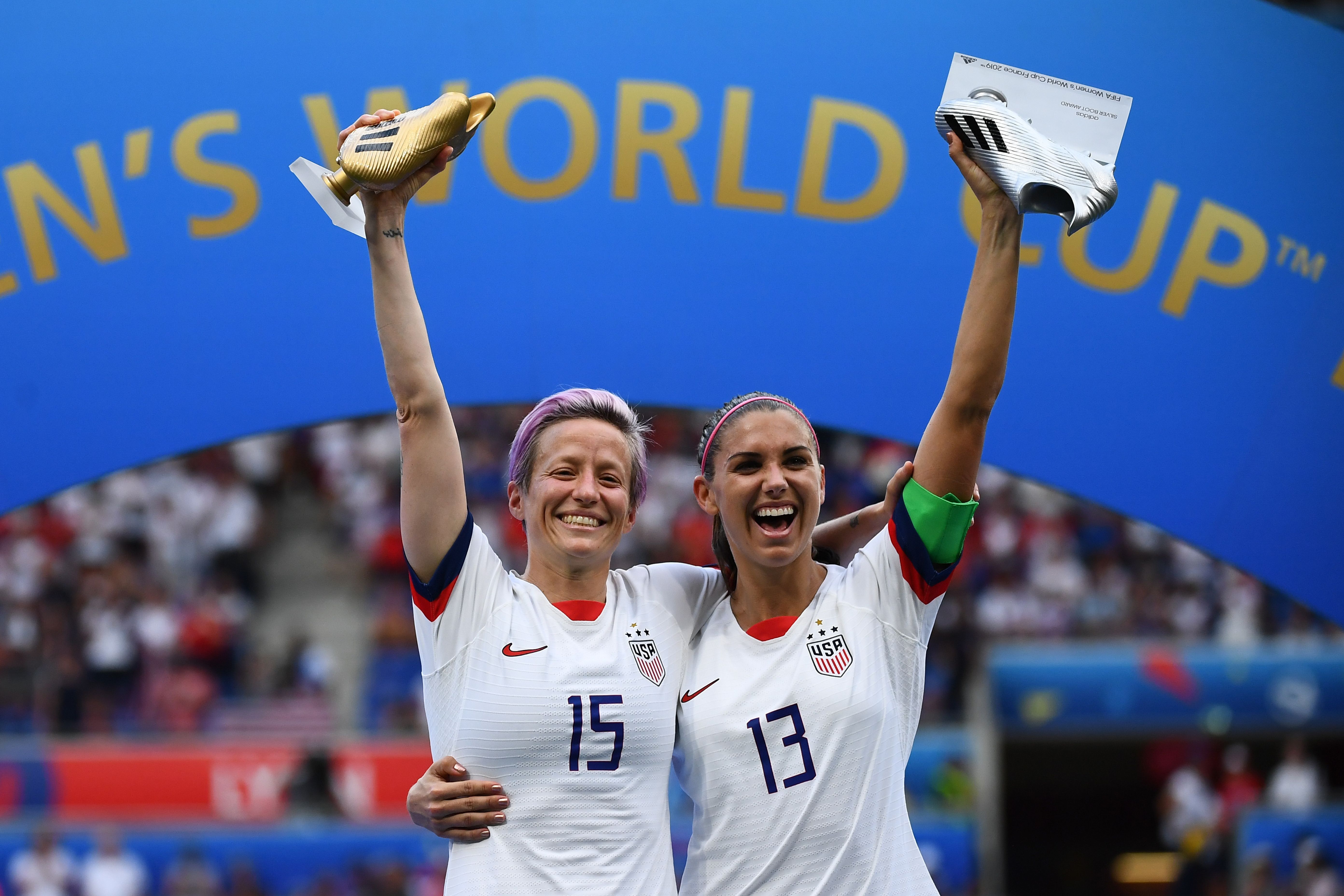 United States' forward Megan Rapinoe (L) poses with the Golden Boot and United States' forward Alex Morgan with her Silver boot.