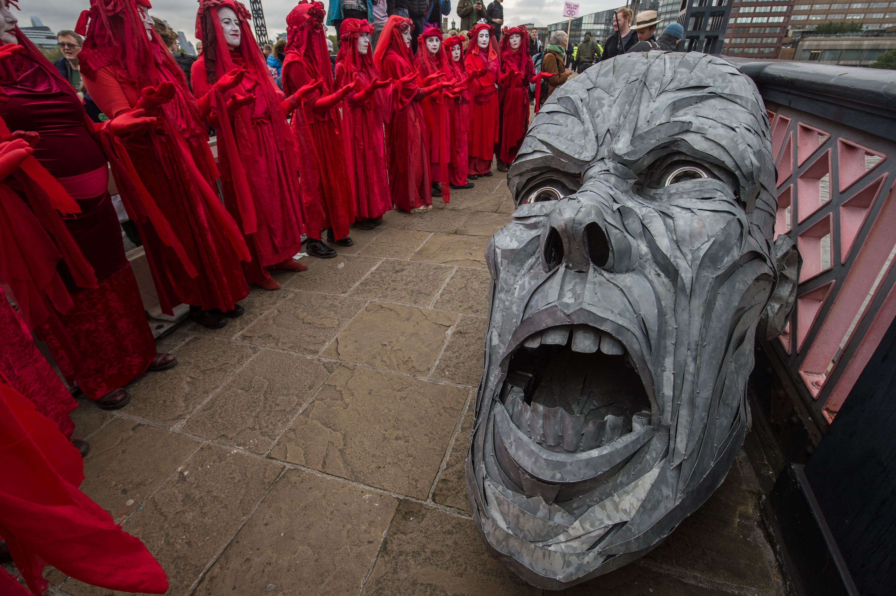 Theatre group by a sculpture on Lambeth Bridge on October 7, 2019 in London, England.