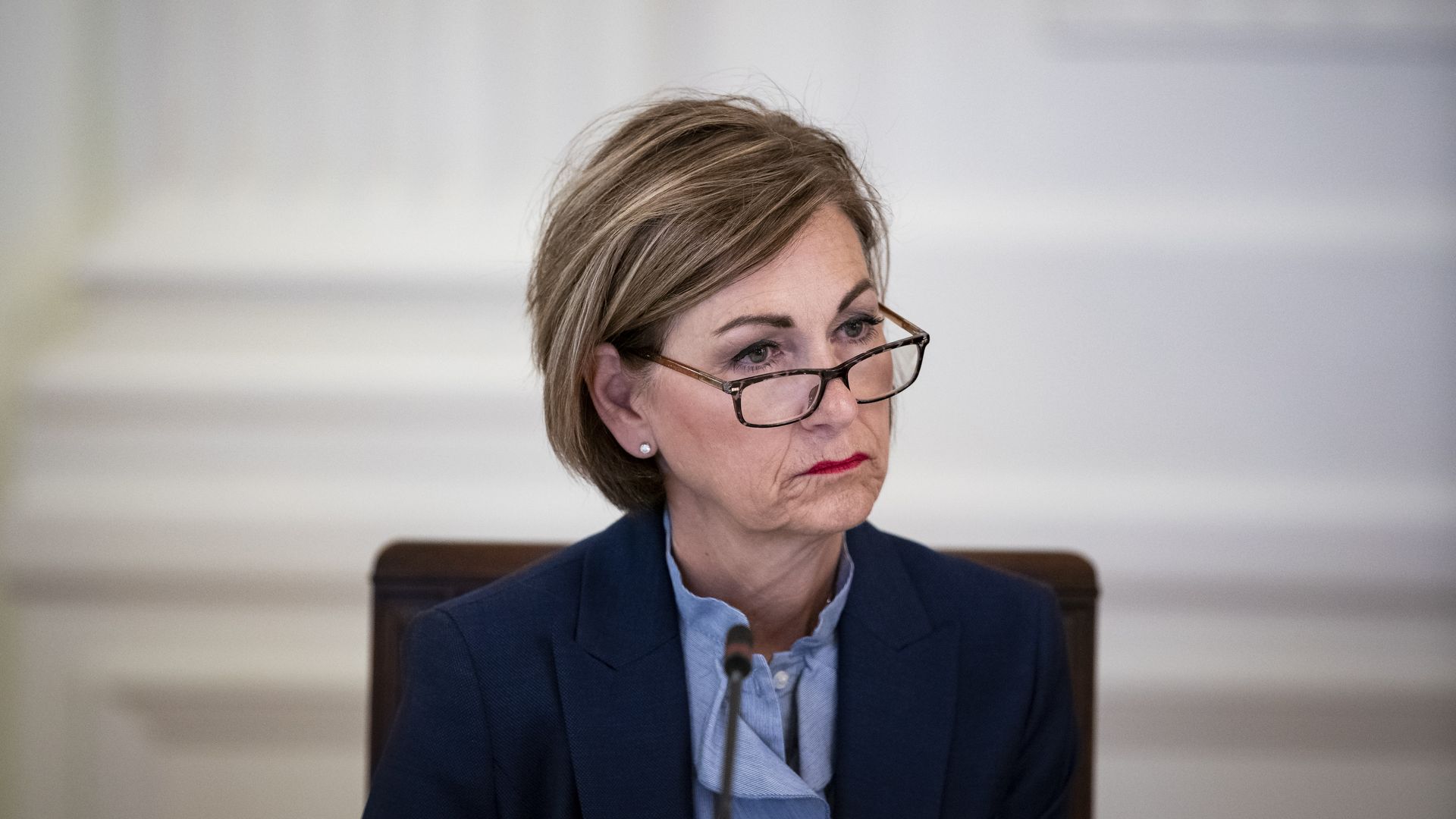 Iowa Gov. Kim Reynolds listens on during a meeting in the White House in 2020.