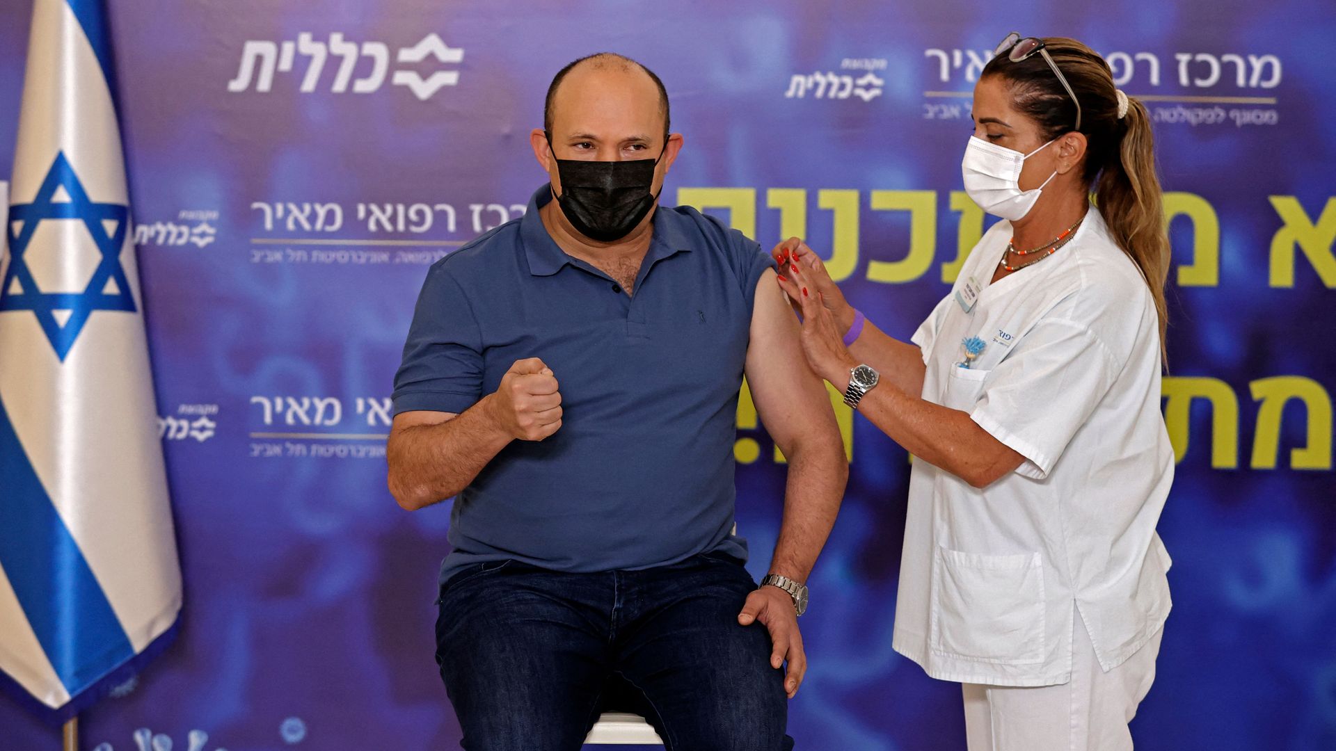 Israeli Prime Minister Naftali Bennett receives a booster shot of vaccine against the coronavirus at Meir Medical Center in the central Israeli city of Kfar Saba, on August 20.