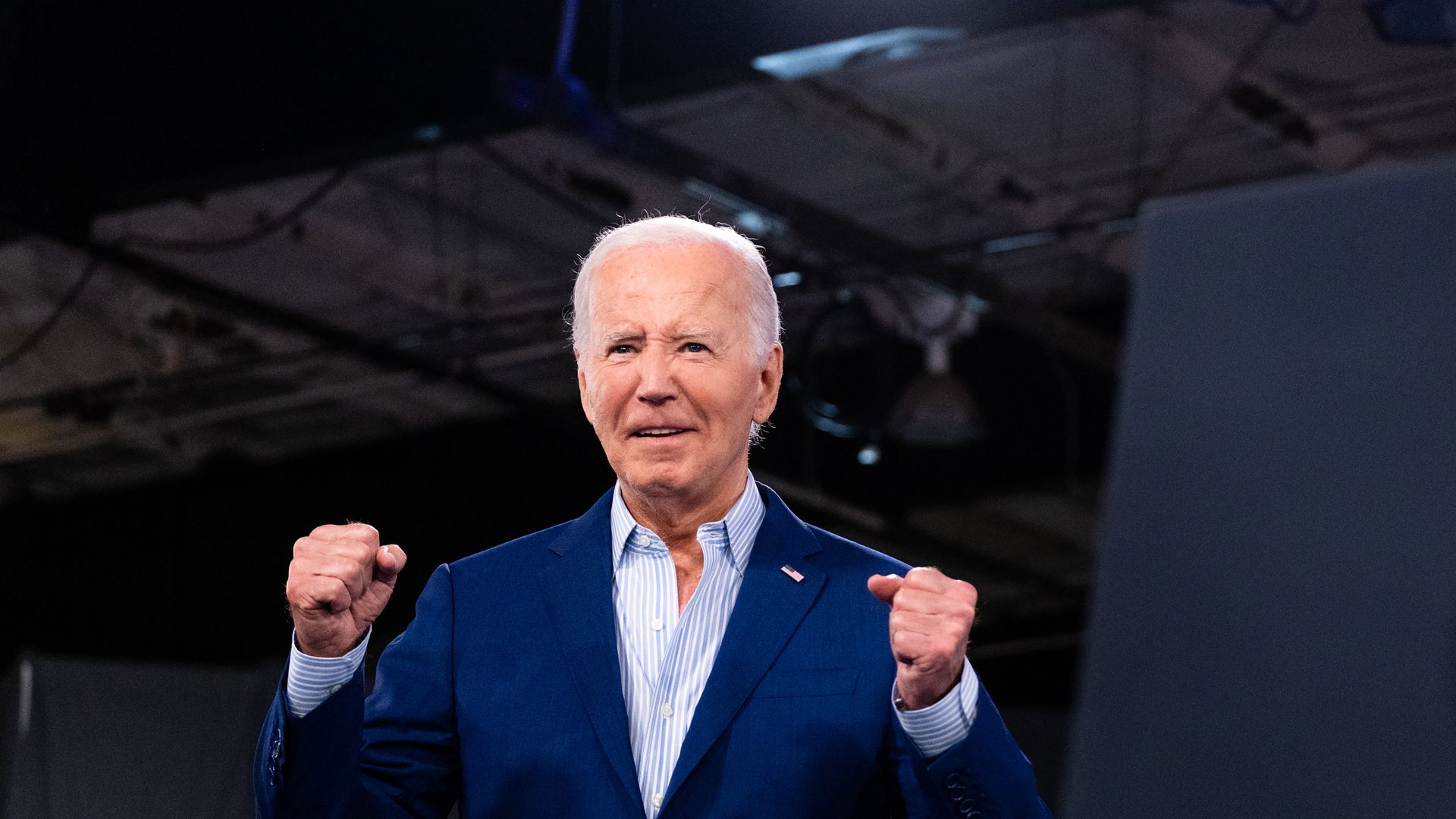 Joe Biden smiles with clenched fists.