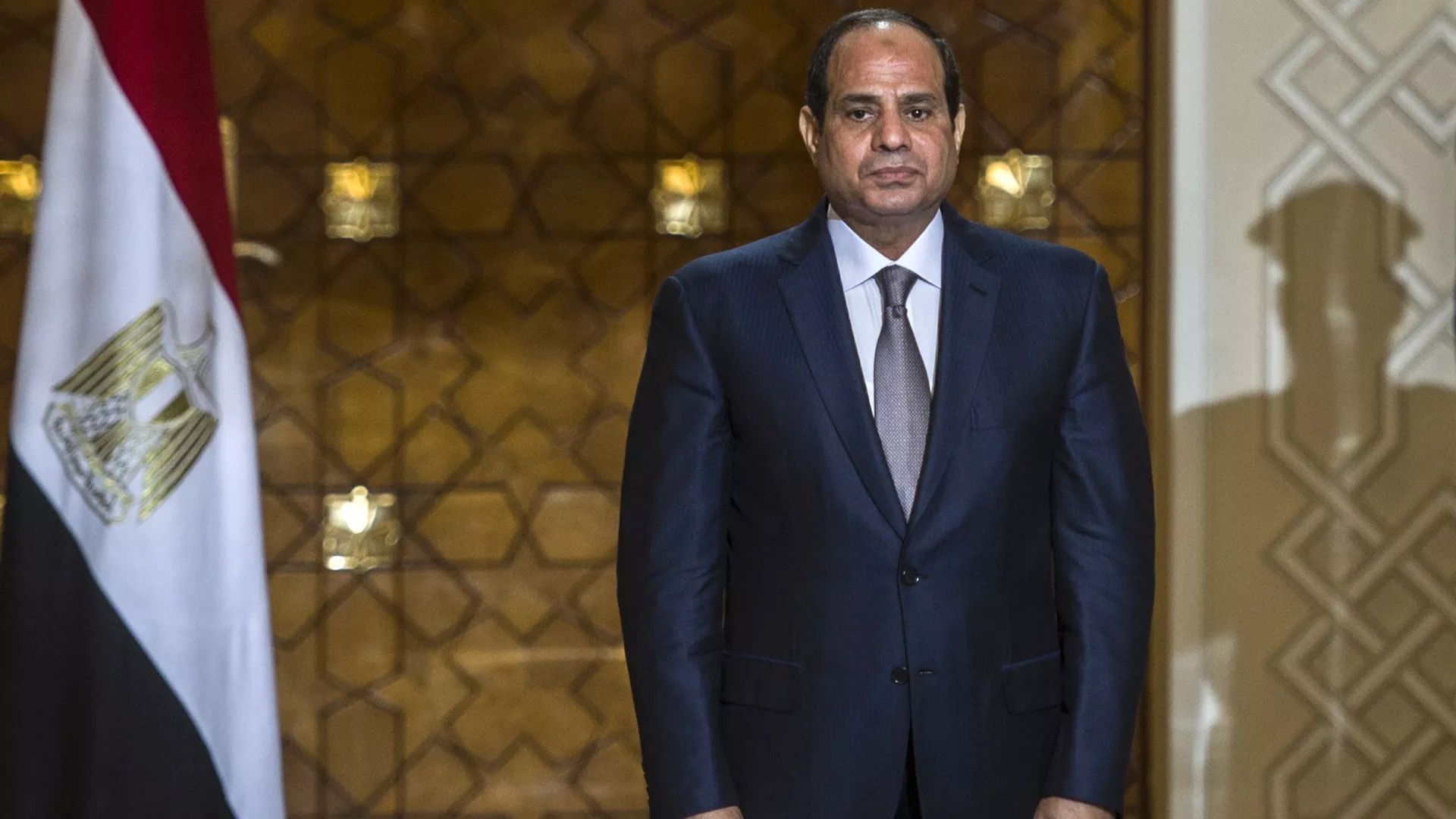 Egyptian President Abdel Fattah al-Sisi is seen standing at attention.