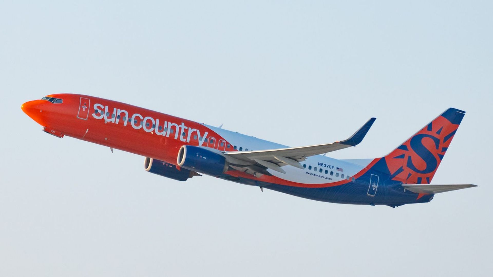 A Sun Country plane in the air