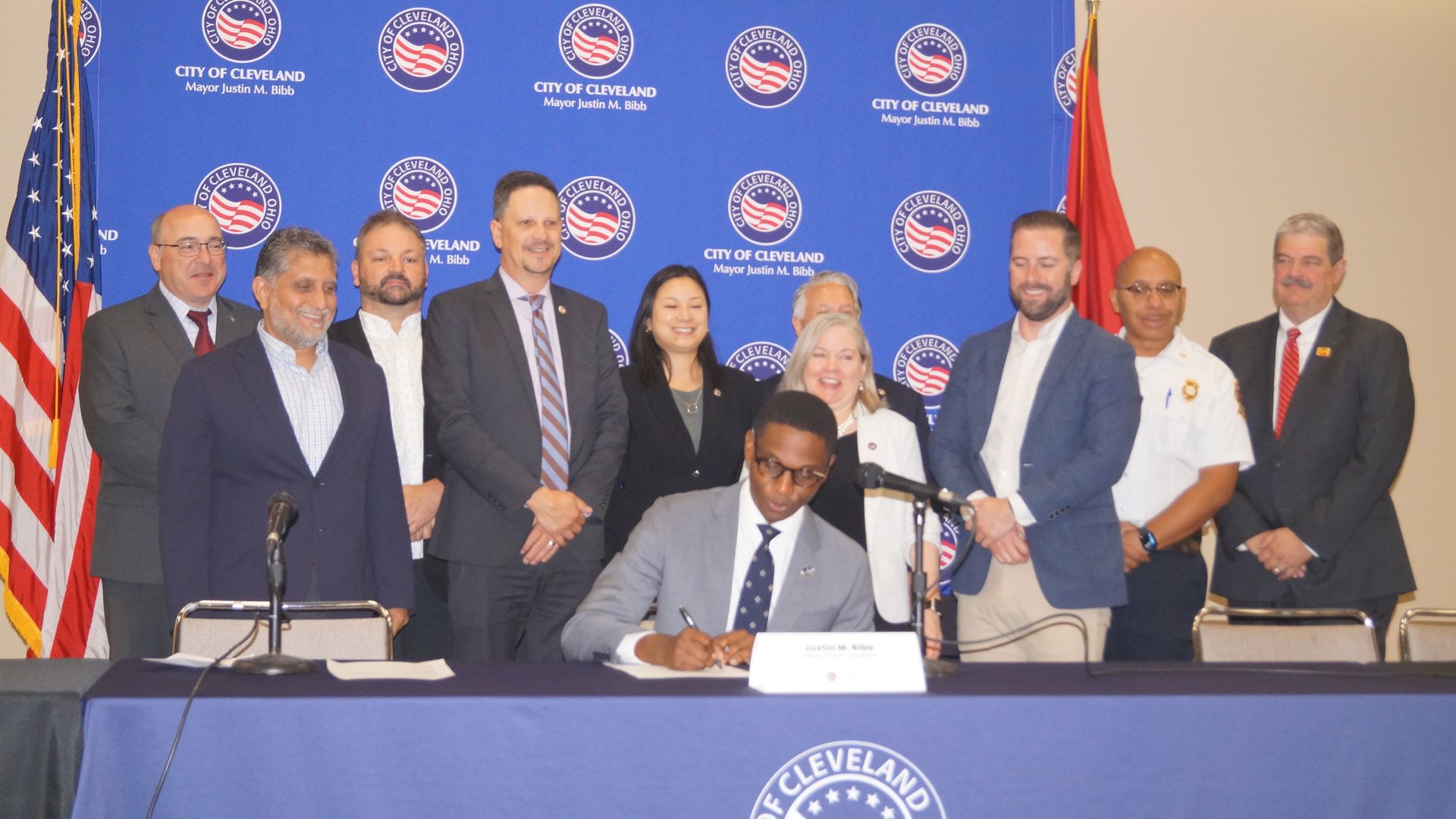 Cleveland Mayor Justin Bibb signs an executive order flanked by city officials 