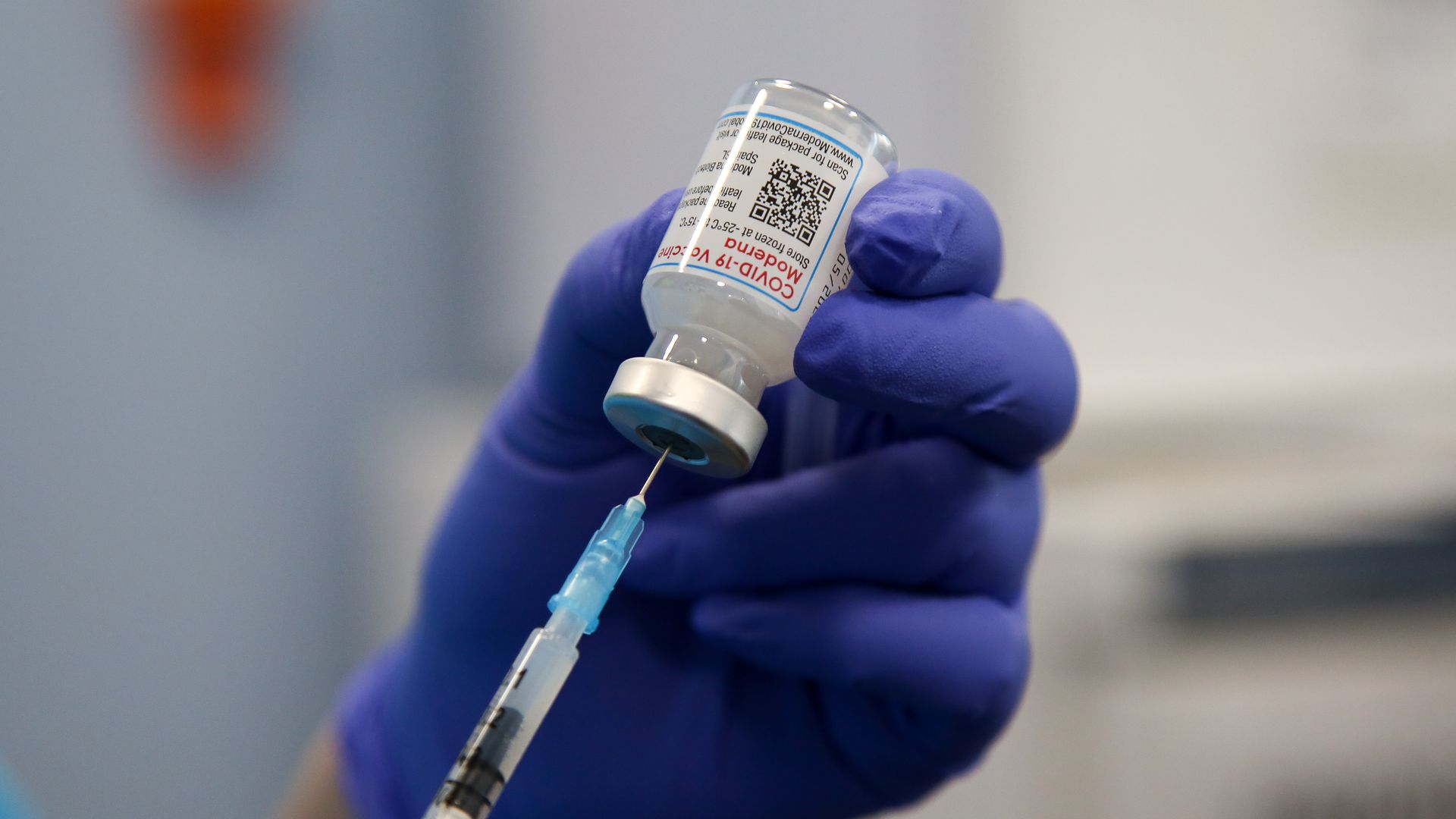 A health worker draws the Moderna COVID-19 vaccine as she prepares to administer the spring booster also known as fourth jab to a person at a vaccination clinic.
