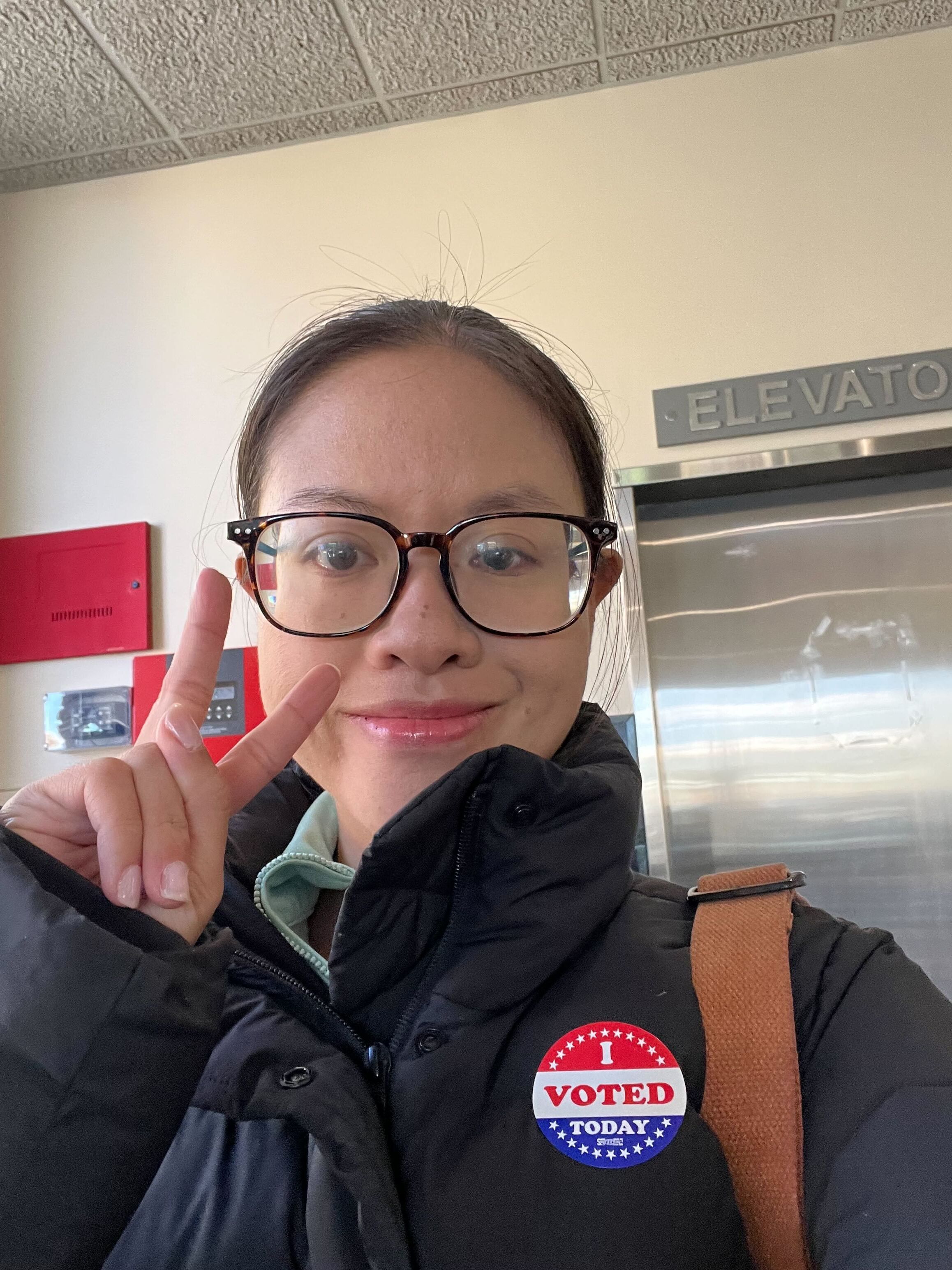 Photo shows a woman with an "I voted today" sticker.