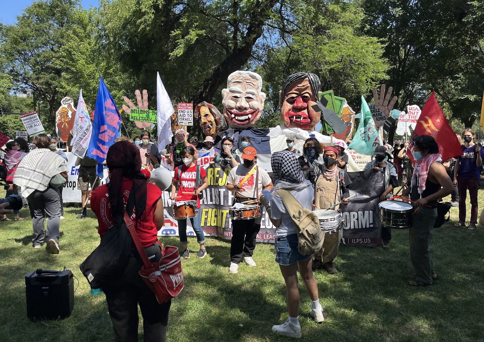 People holding large, garish puppets.