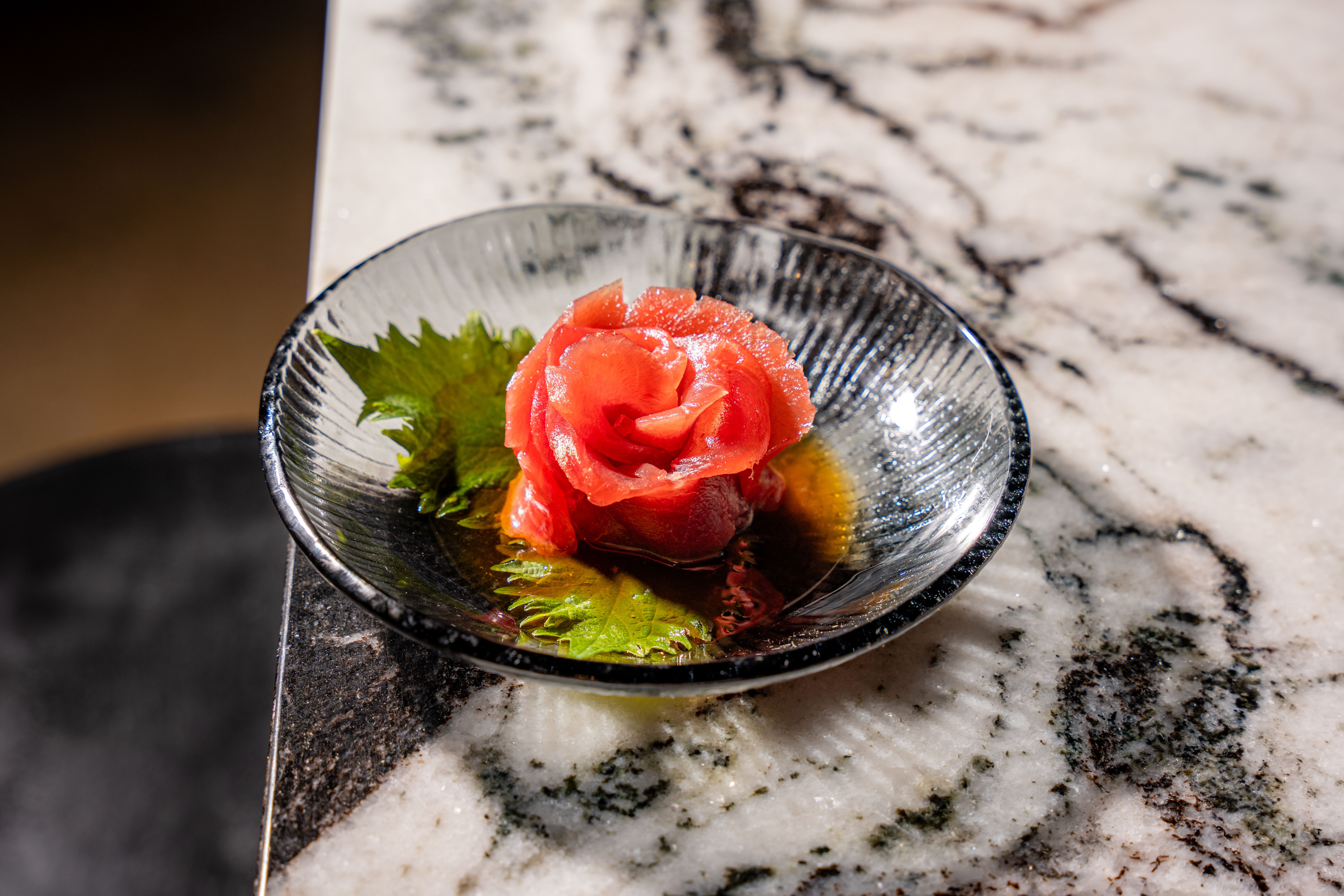Sashimi in the shape of a rose on a marble countertop 